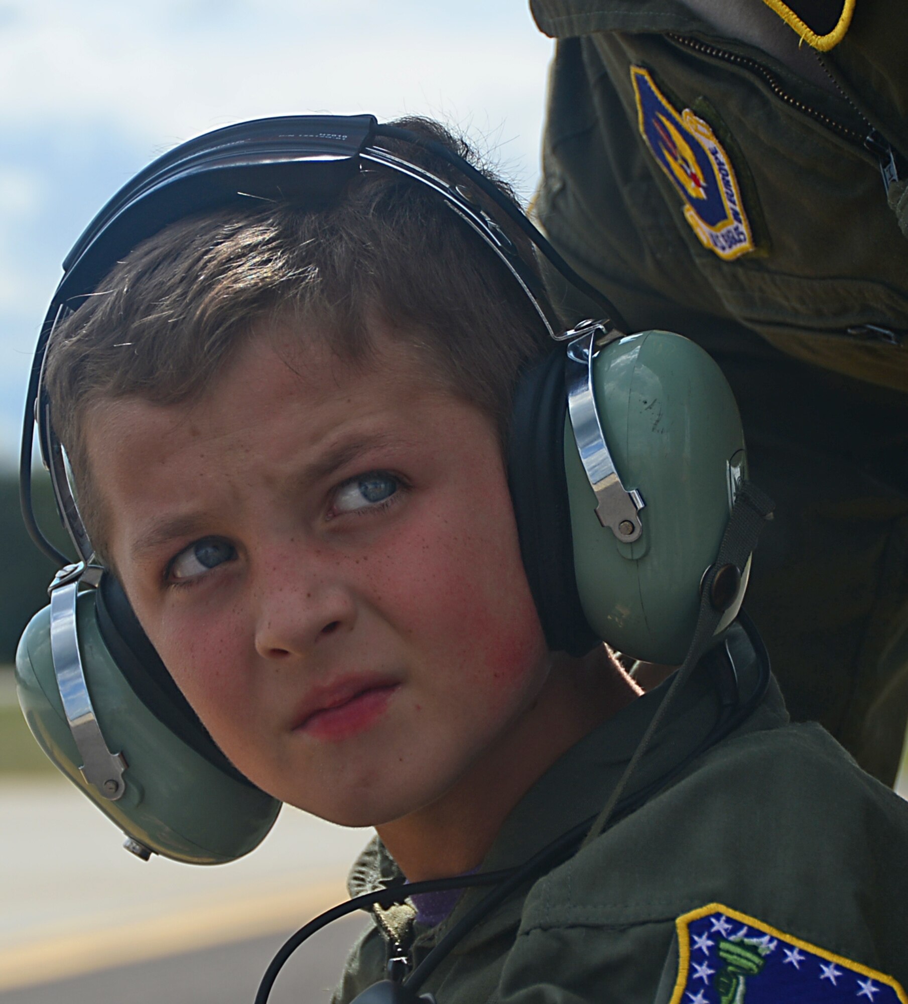 Sam Jerred, 9, observes aircraft on the flightline during a “Pilot for a Day” event at Royal Air Force Lakenheath, England, Aug. 4, 2014. This program gives the opportunity for local children with serious illnesses and conditions to learn about the Air Force mission, and it provides them with a day to escape their normal hospital routine. (U.S. Air Force photo by Airman 1st Class Erin O’Shea/Released) 