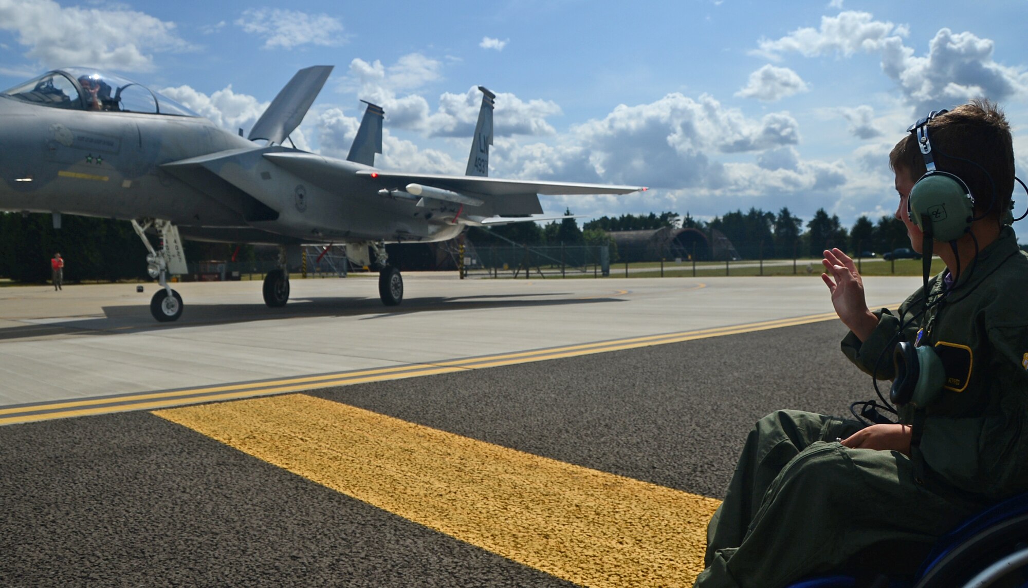 Sam Jerred, 9, waves to a 493rd Fighter Squadron F-15C fighter pilot before take off during a “Pilot for a Day” event at Royal Air Force Lakenheath, England, Aug. 4, 2014. Throughout the day, Sam participated in events such as sitting inside an F-15E Strike Eagle, touring the air traffic control tower and watching aircraft take off from the runway. (U.S. Air Force photo by Airman 1st Class Erin O’Shea/Released) 