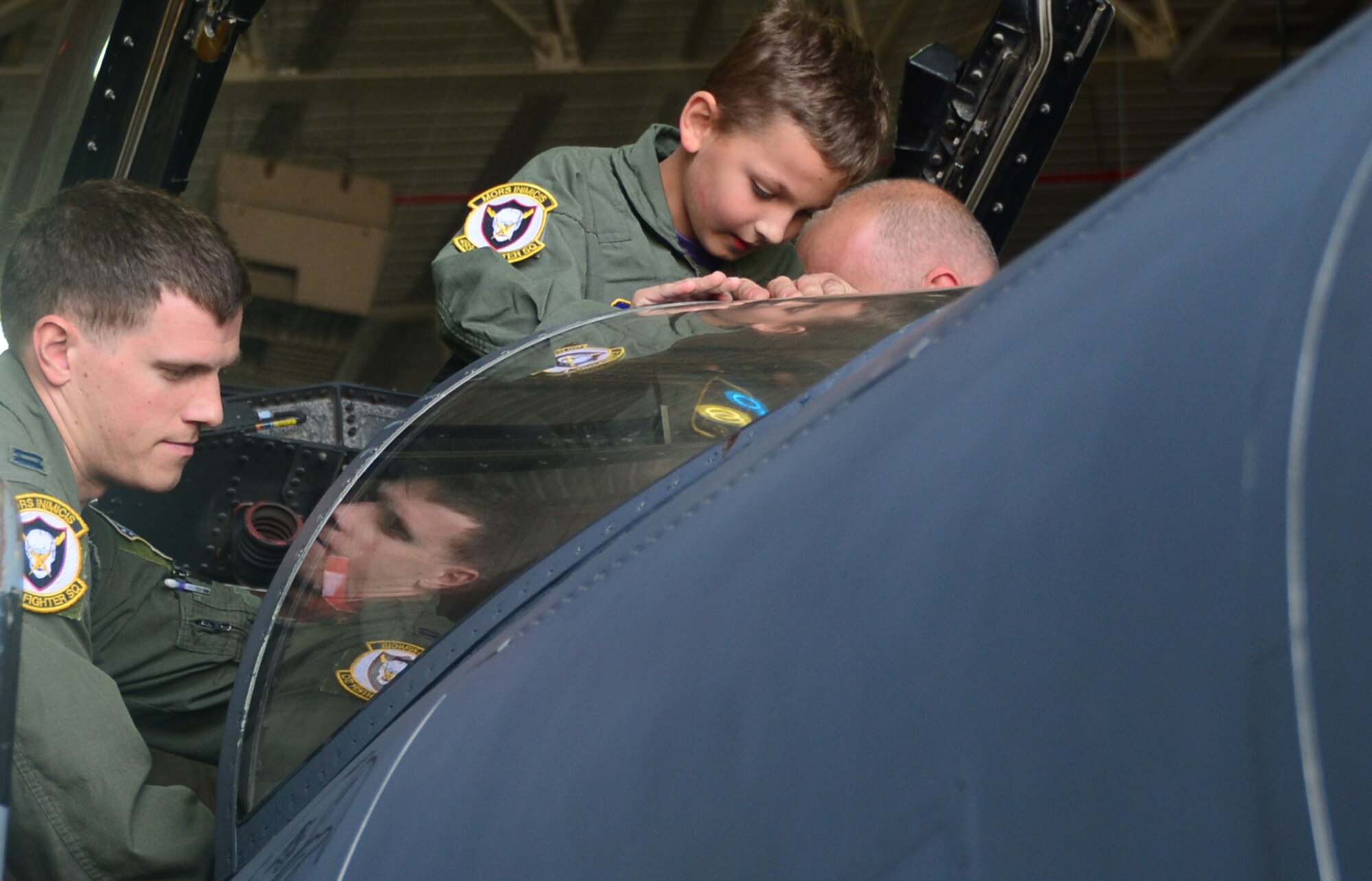 Capt. Matthew Tanis, 493rd Fighter Squadron F-15C Eagle pilot, helps Sam Jerred, 9, into an F-15E Strike Eagle cockpit during a “Pilot for a Day” event at Royal Air Force Lakenheath, England, Aug. 4, 2014. This program gives the opportunity for local children with serious illnesses and conditions to learn about the Air Force mission, and it provides them with a day to escape their normal hospital routine. (U.S. Air Force photo by Airman 1st Class Erin O’Shea/Released) 