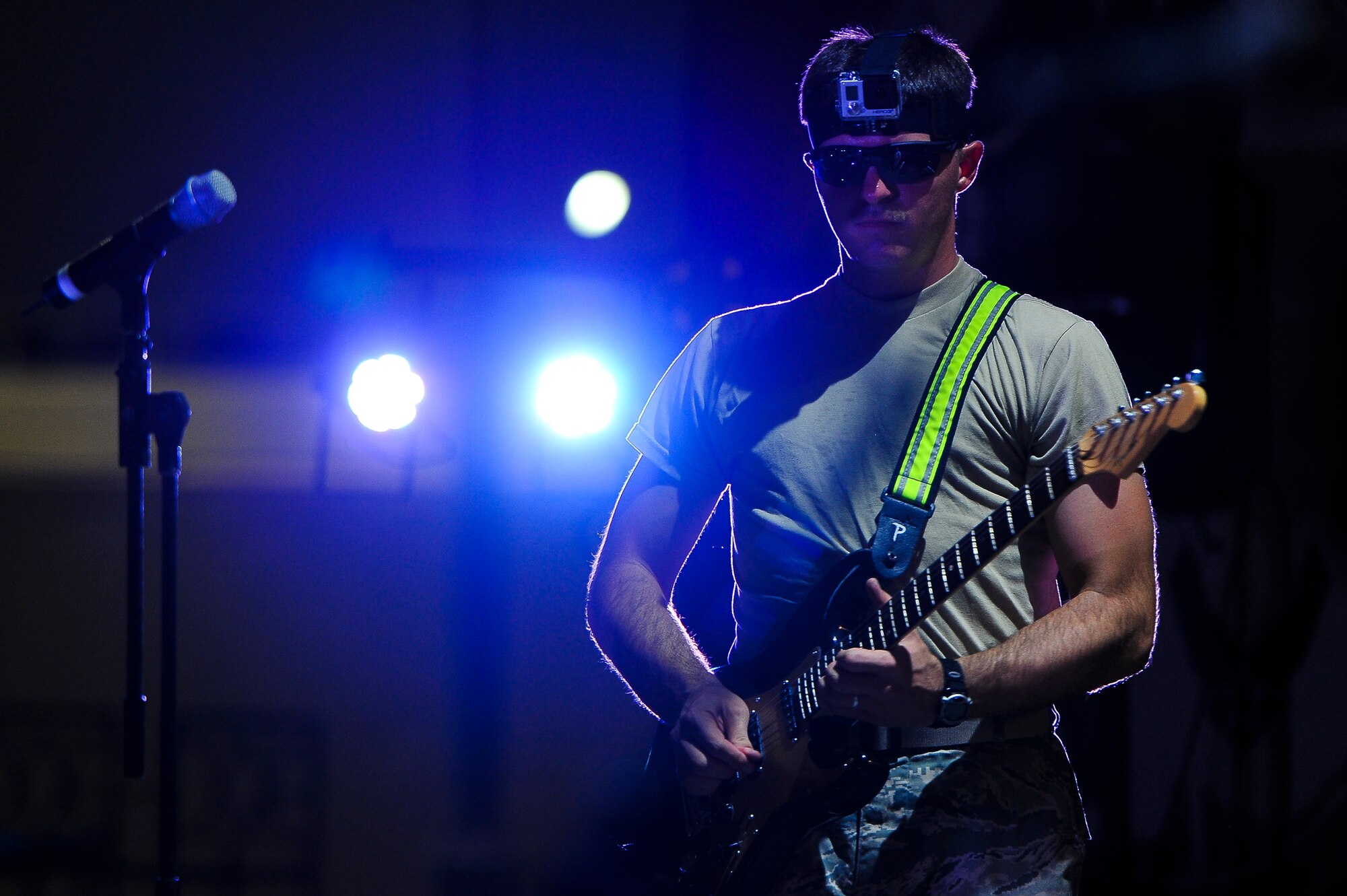 Staff Sgt. Charles Cothran, an Air Force Central Command Starflifter Band member, plays the guitar during a performance for the 380th Air Expeditionary Wing Aug. 1, 2014, at an undisclosed location in Southwest Asia. The band played at multiple locations around the base during their visit.Scalf/Released)