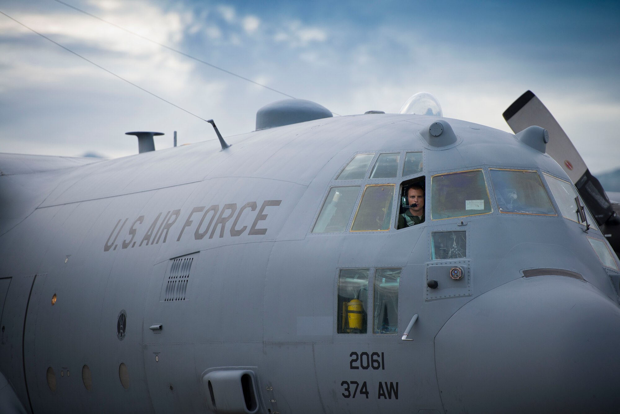 A pilot with the 36th Airlift Squadron performs pre-flight checks on a C-130 Hercules prior to an off-site training sortie Aug. 1 2014 at Joint Base Elmendorf-Richardson, Alaska.  The 36 AS conducted C-130 Hercules aerial combat training with paratroopers from the 25th Infantry Division.. (U.S. Air Force photo by Staff Sgt. Chad C. Strohmeyer/Released)