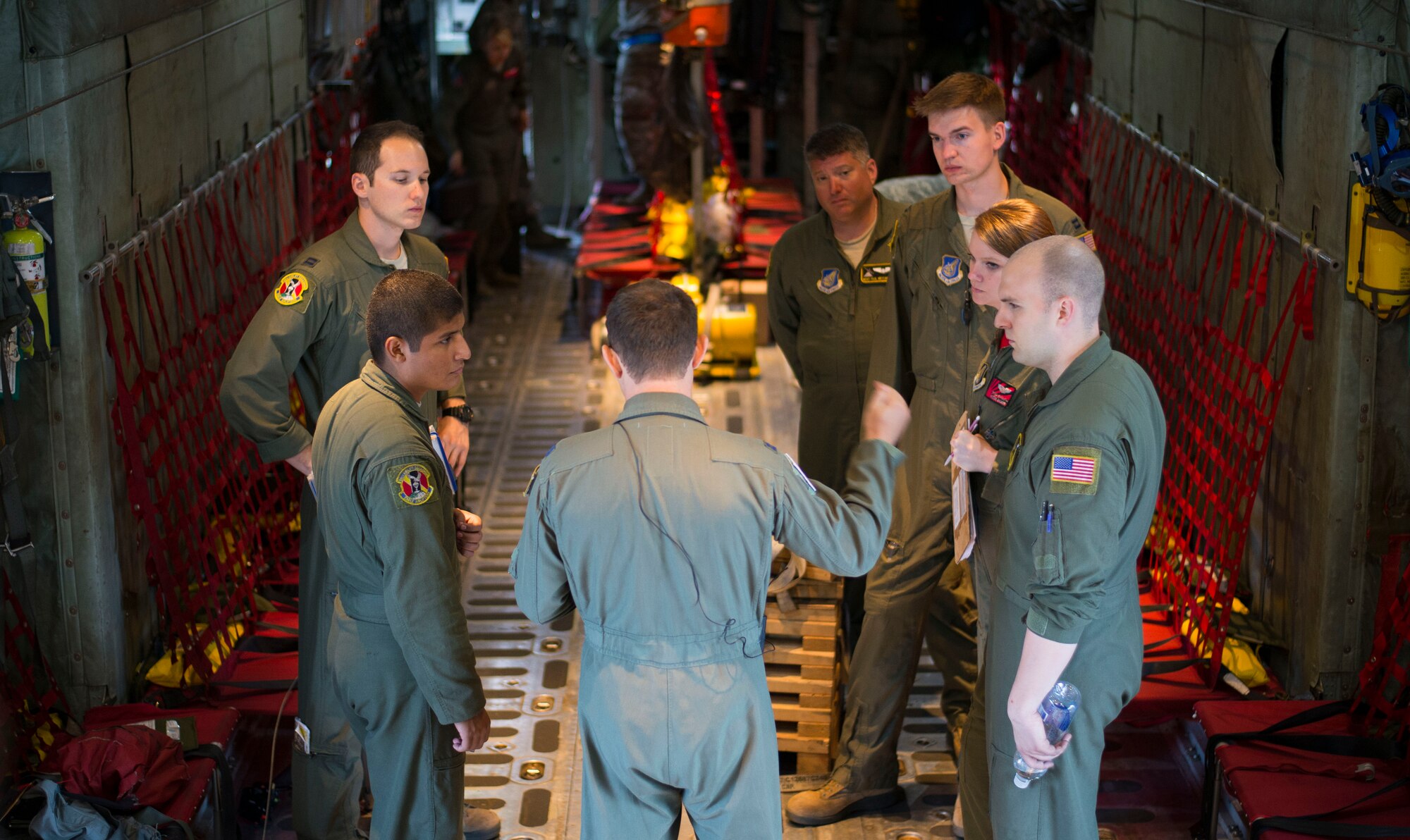Aircrew from the 36th Airlift Squadron receive a pre-flight briefing prior to an off-site training sortie Aug. 2, 2014 at Joint Base Elmendorf-Richardson, Alaska. The 36 AS conducted C-130 Hercules aerial combat training with paratroopers from the 25th Infantry Division. (U.S. Air Force photo by Staff Sgt. Chad C. Strohmeyer/Released)