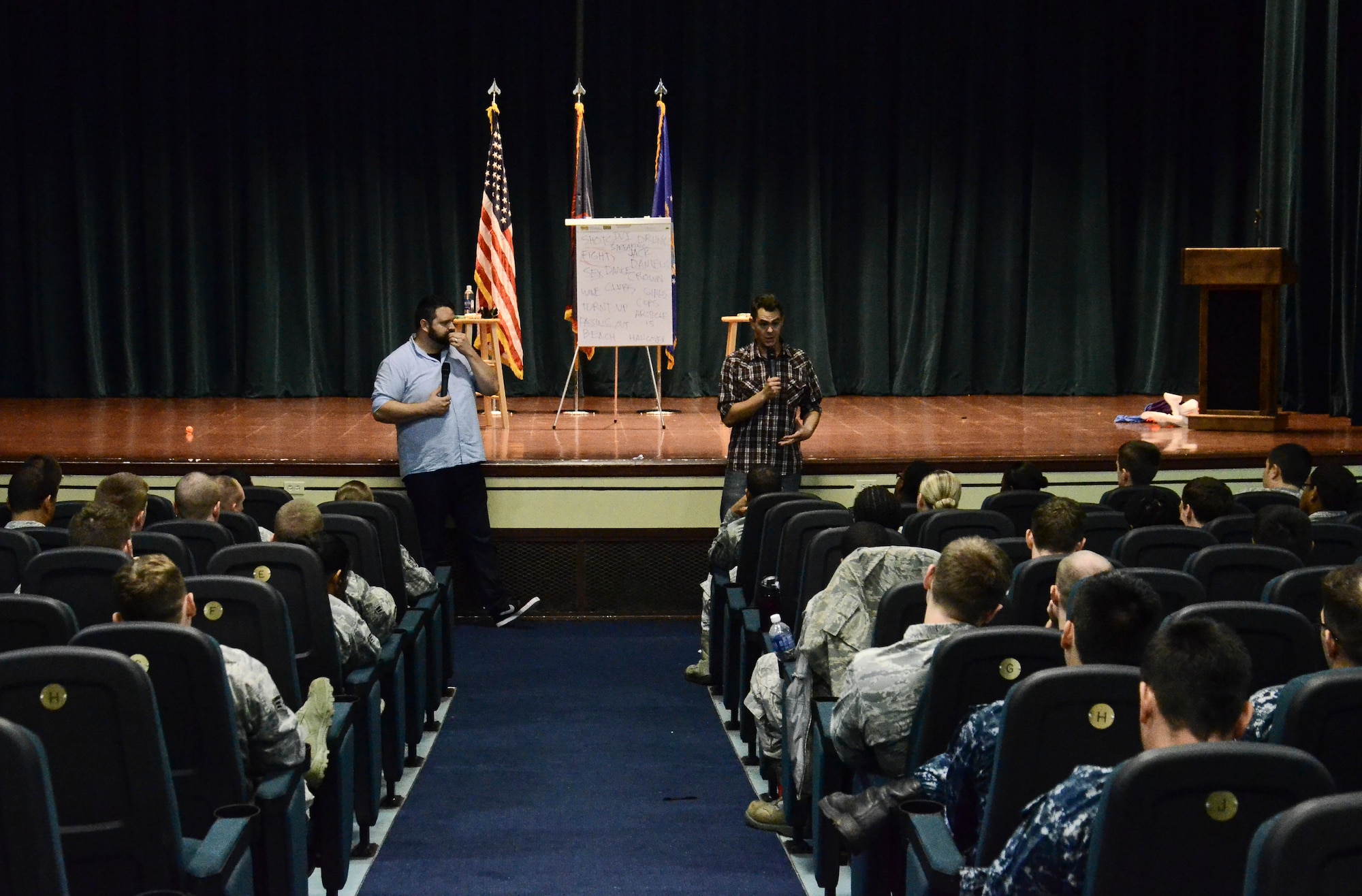 Colin Sweeney and Bryce Wissel, both "A Shot of Reality With a Comedy Chaser" cast members, explain how people who drink before the age of 21 are more likely to have an alcohol dependency later in life, July 31, 2014, on Andersen Air Force Base, Guam.  Joint Region Marianas sponsored the comedy show designed to educate Airmen and Sailors on the dangers and responsibilities that come with drinking alcohol. (U.S. Air Force photo by Staff Sgt. Robert Hicks/Released)