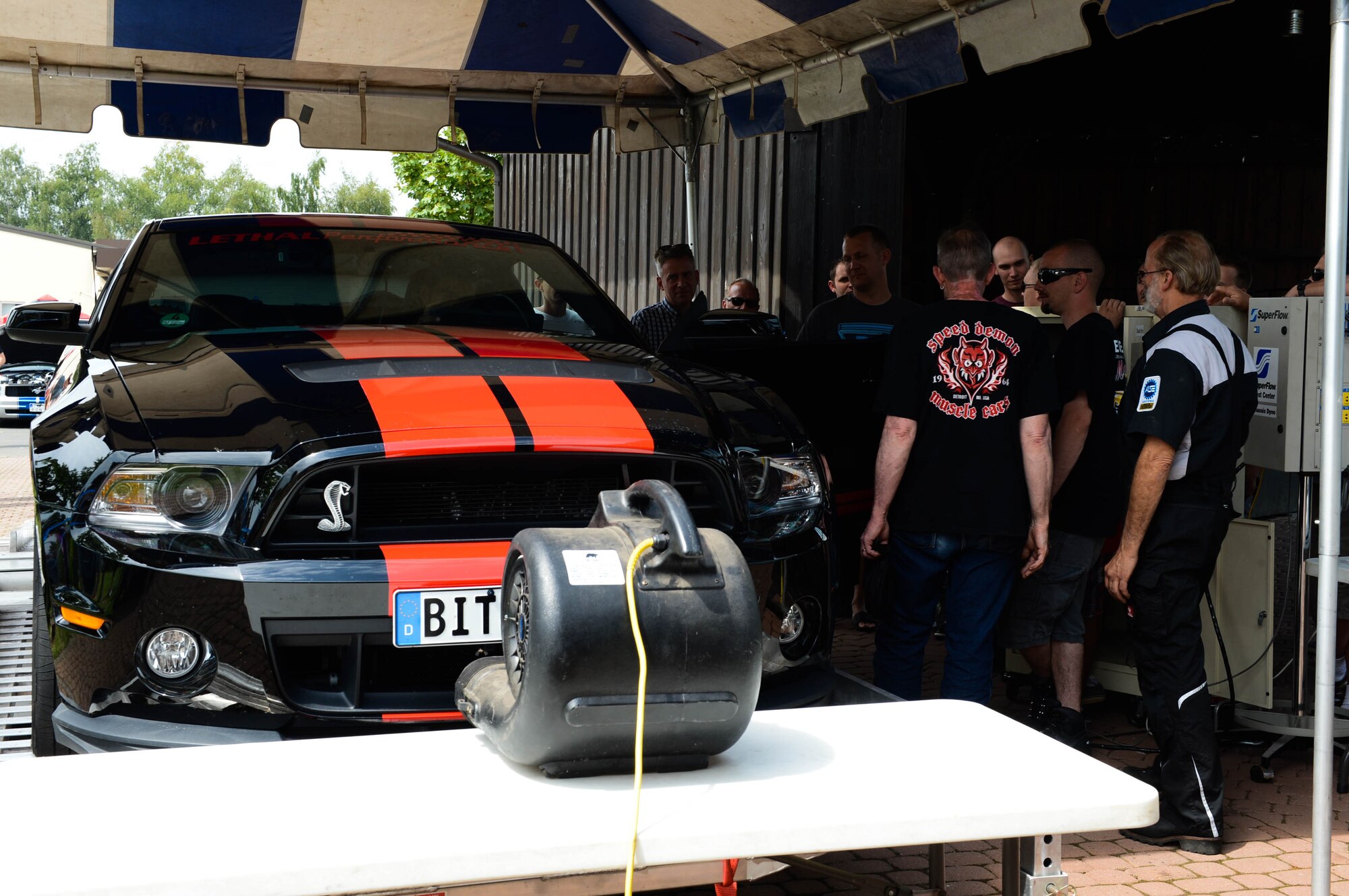 Judges run tests on U.S. Air Force Staff Sgt. Josh Hoke's car, a Motor Weekend competitor and Whitney, Texas native, at Spangdahlem Air Base, Germany, Aug. 2, 2014. The judges measured the output of the 2012 Ford Shelby GT-500 rear-wheel horsepower. The owner with the highest output received a trophy. (U.S. Air Force photo by Airman 1st Class Kyle Gese/Released)