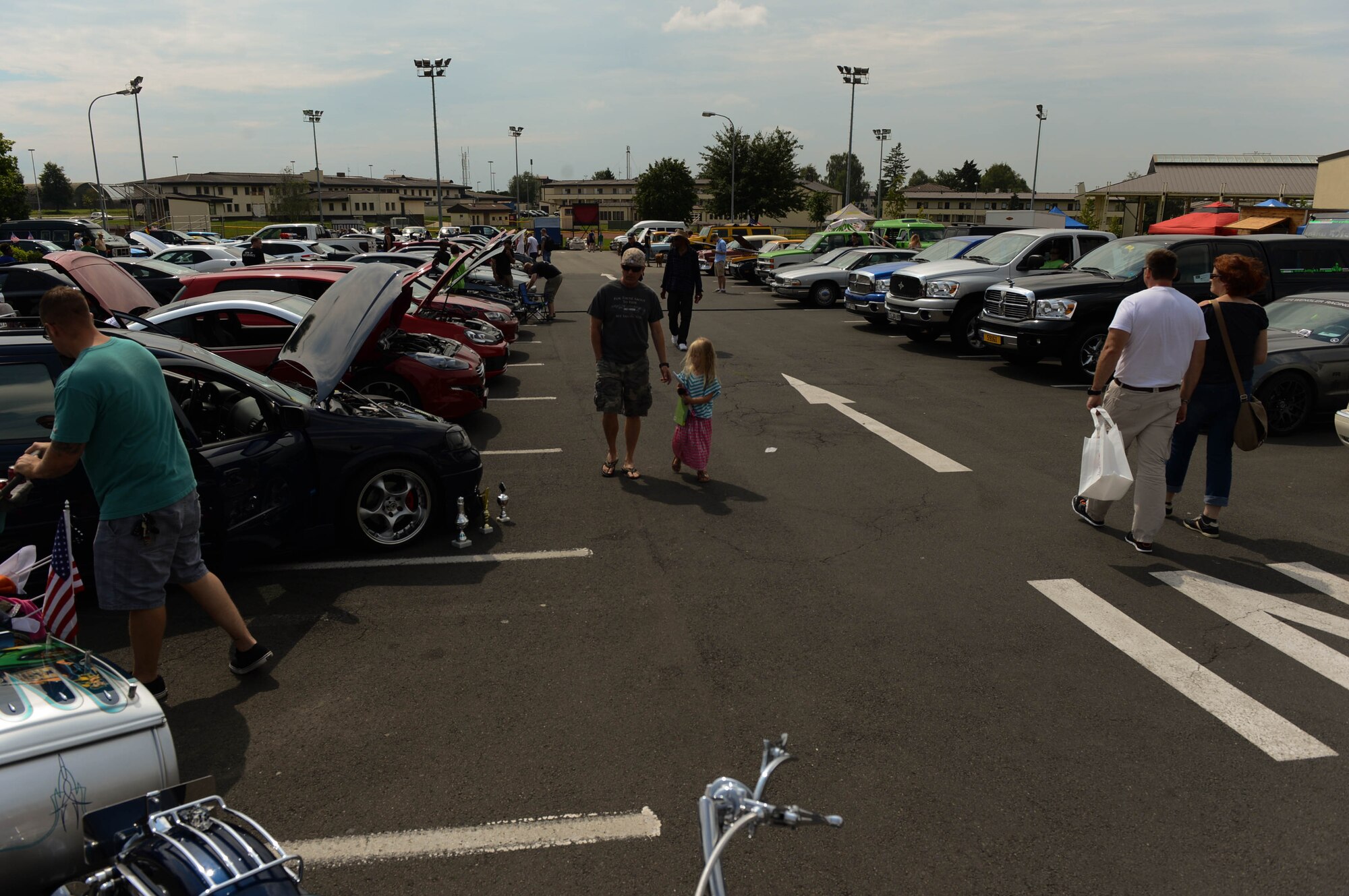 People display their vehicles in the Motor Weekend car show at Spangdahlem Air Base, Germany, Aug. 2, 2014. The 52nd Force Support Squadron sponsored the car show, and more than 180 people registered their vehicles. (U.S. Air Force photo by Airman 1st Class Kyle Gese/Released)