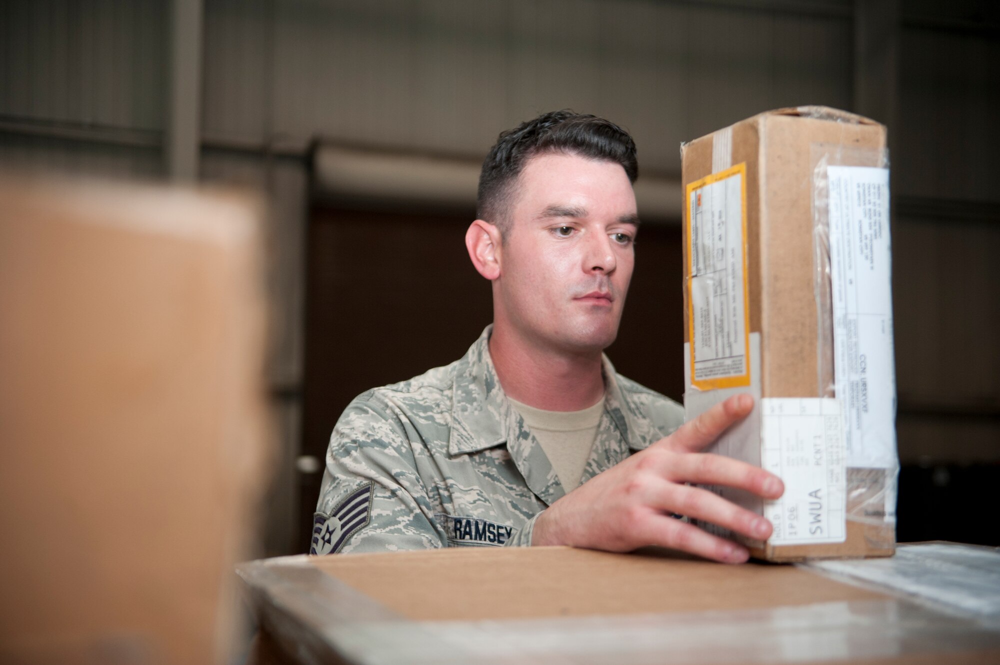Staff Sgt. John Ramsey, 51st Logistics Readiness Squadron cargo receiving supervisor, inspects part of a mission capable aircraft parts shipment in Bldg. 824 at Osan Air Base, Republic of Korea, Aug. 4, 2014. Ramsey is this week’s Airman Spotlight winner. (U.S. Air Force photo/Airman 1st Class Ashley J. Thum)