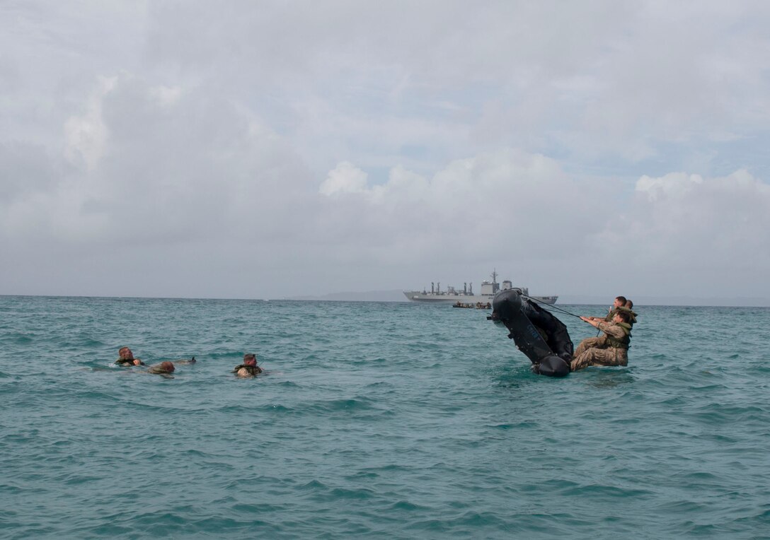 Marines broach their combat rubber raiding craft as part of a month-long coxswains course July 22, 2014 at White Beach Naval Facility, Okinawa, Japan. The purpose of broaching is to simulate a small boat that has capsized in turbulent waters and complete the steps necessary to set the craft in an upright position.  Following completion of the course the Marines will gain an additional military occupational specialty of 0316, or Combat Rubber Raiding Craft coxswain. The Marines are with various units assigned to 3rd Marine Division, III Marine Expeditionary Force.