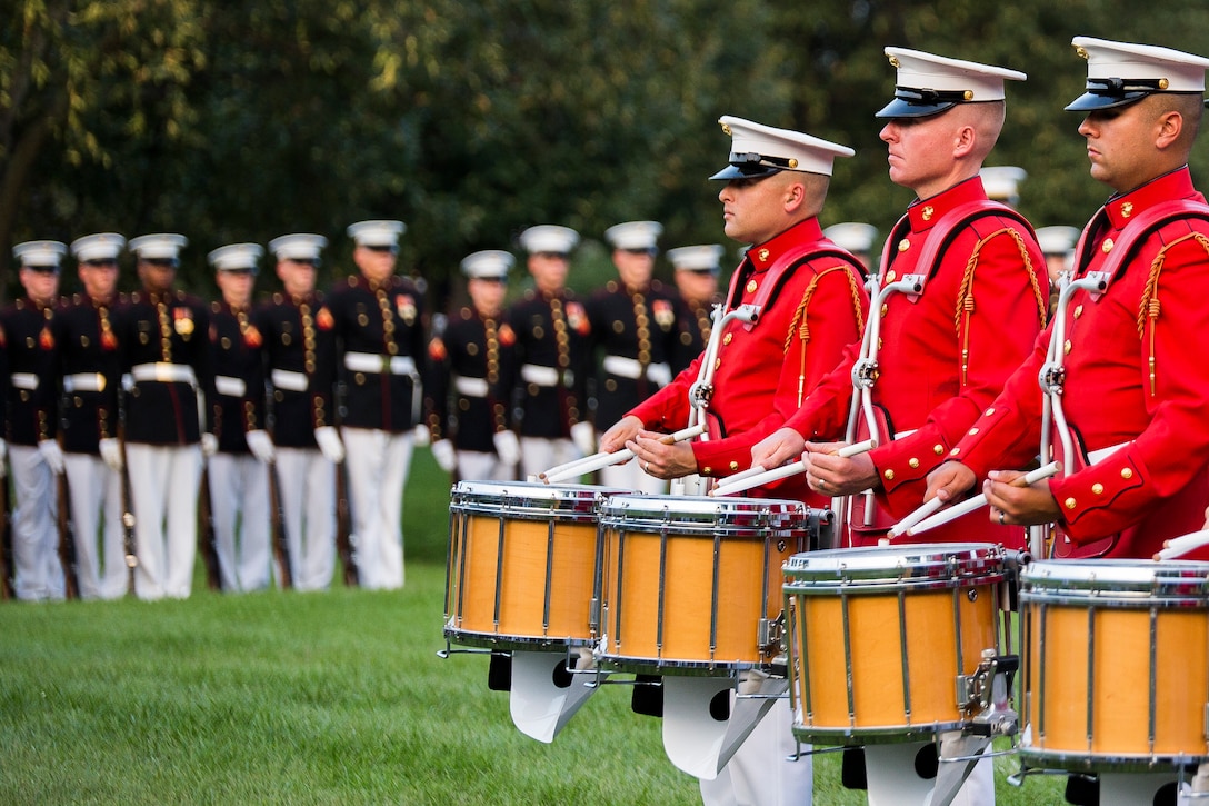 The U.S. Marine Drum & Bugle Corps performs during a Tuesday Sunset Parade at the Marine Corps War Memorial in Arlington, Va., Aug. 5, 2014. (Official Marine Corps photo by Staff Sgt. Paula Reth/Released)