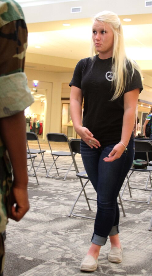 U.S. Marine Corps Lance Cpl. Kristin Toler, a field radio operator with the Fire Support Coordination Center, 10th Marine Regiment, 2nd Marine Division, teaches New Bern Young Marines drill movements during a Young Marine meeting at the New Bern Mall in New Bern, N.C., July 18, 2014. Toler spent most of her life as a Young Marine before joining the Marine Corps in 2013. Now she gives back to the organization by volunteering once a week. (U.S. Marine Corps photo by Sgt. Dwight A. Henderson/Released)