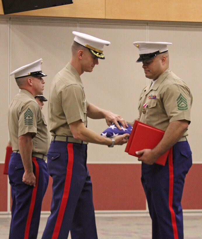 U.S. Marine Corps Gunnery Sgt. Marvin Faulcon, right, receives his retirement flag from Maj. Ryan Gordinier, Recruiting Station Richmond’s Commanding Officer, during his retirement ceremony at RS Richmond in Richmond, Va., July 25, 2014. Faulcon, a career recruiter retired after 21 years of service. For his dedicated and selfless service to the command and the Corps, Faulcon was awarded the Meritorious Service Medal during the ceremony. (U.S. Marine Corps photo by Cpl. Aaron Diamant/Released)