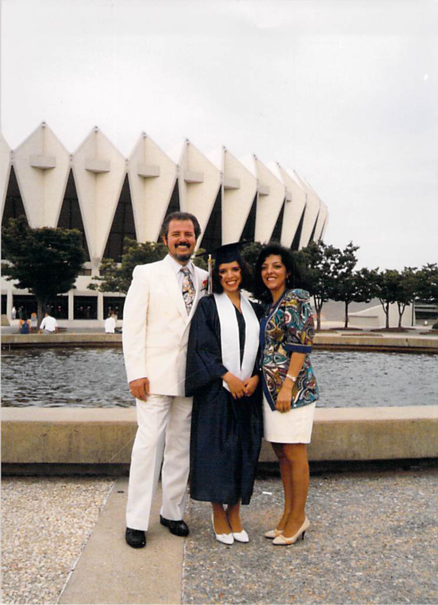 Master Sgt. Liesbeth Bowen (center) stands with her father, Roberto Henriquez, and mother, Liliana Henriquez, while celebrating her college graduation at the Hampton Coliseum in Hampton, Va. Bowen,the  633rd Wing Staff Agency first sergeant, graduated in 1995. (Courtesy photo)