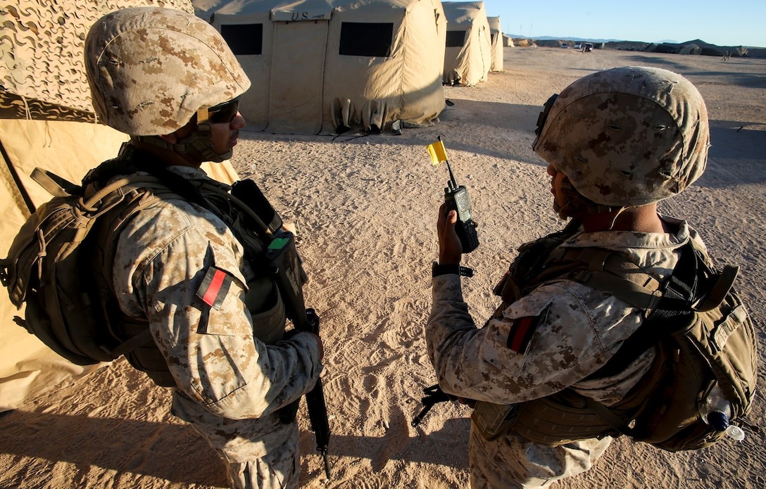 Lance Cpl. Luis Martinez, left, from Jacksonville, Fla., and Lance Cpl. Emilio Tetuan from Topeka, Kan., both with 1st Law Enforcement Battalion, Brigade Headquarters Group, 1st Marine Expeditionary Brigade and tasked to provide security for Camp Francis as Guardian Angels during Large Scale Exercise 2014, perform a radio functionality check aboard Marine Corps Air Ground Combat Center Twentynine Palms, Calif., Aug. 5. LSE-14 is a bilateral training exercise being conducted by 1st MEB to build U.S. and Canadian forces’ joint capabilities through live, simulated, and constructive military training activities from Aug. 8-14. (U.S. Marine Corps photo by Cpl. Rick Hurtado/Released)