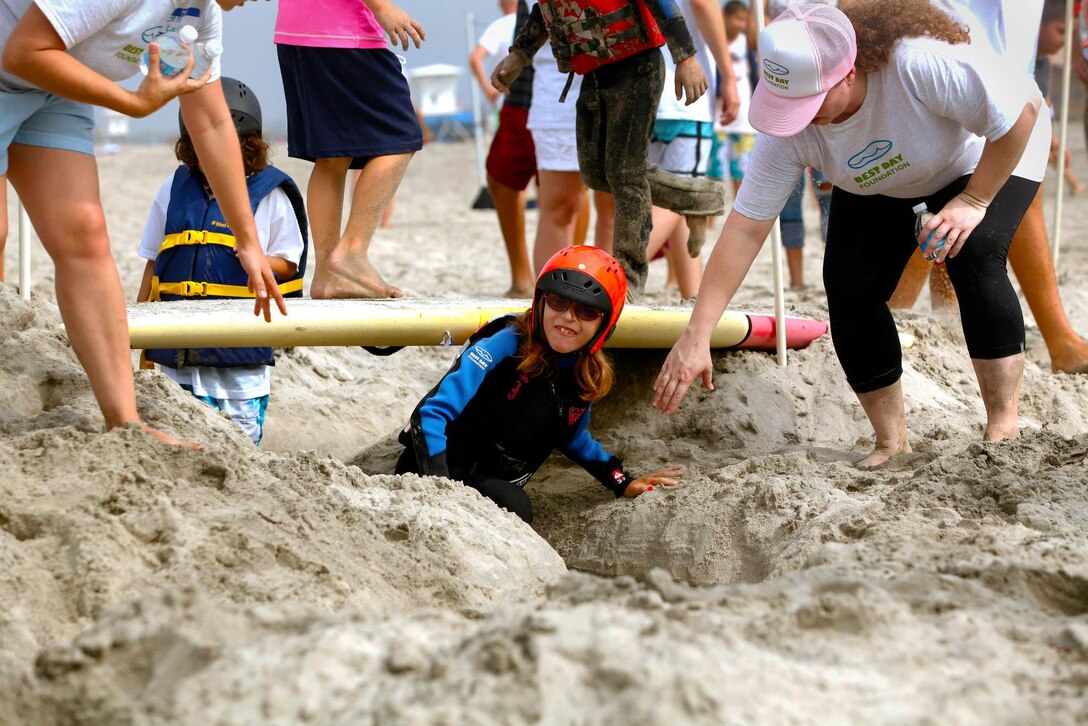 Kaelyn, 10, runs through an obstacle course during the Exceptional Family Member Program beach event at Del Mar Beach, Aug. 2-3. 

The Best Day Foundation Orange County Chapter hosted the event for special needs children that are enrolled in the EFMP. The event provided activities such as surfing, body boarding, kayaking and more. 

“For families like us, we don’t have a lot of opportunities for our kids to experience what the normal family might,” said Jolanda Graham, parent and volunteer EFMP family representative.  

Involved parents such as Graham also appreciate experienced volunteers who make these activities safe and possible.
