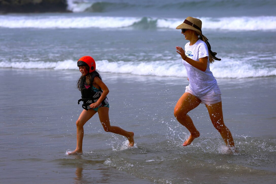 Laura Delpena, an event volunteer, and Kaylee, 7, enjoy time in the ocean during the Exceptional Family Member Program beach event at Del Mar Beach, Aug. 2-3. 

The Best Day Foundation Orange County Chapter hosted the event for special needs children that are enrolled in the EFMP. The event provided activities such as surfing, body boarding, kayaking and more. 

“For families like us, we don’t have a lot of opportunities for our kids to experience what the normal family might,” said Jolanda Graham, parent and volunteer EFMP family representative.  

Involved parents such as Graham also appreciate experienced volunteers who make these activities safe and possible.
