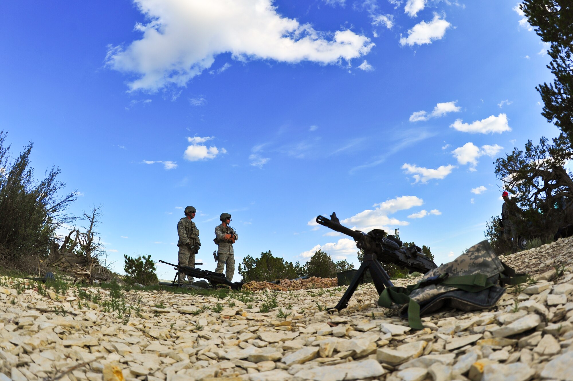Air Force Reservists Senior Airman Cole Green and Airman 1st Class Seth Ham, 310th Security Forces Squadron, wait for further instructions from Tech. Sgt. Daniel M. Reagan, 310th Security Forces Squadron combat arms, before firing their weapons August 2, 2014, at Fort Carson’s Airburst range in Pueblo, Colo.