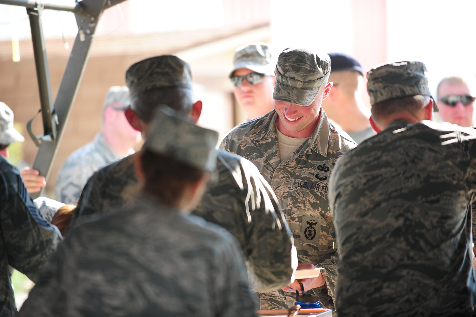 Air Force Reservists from the 310th and 710th Security Forces Squadrons receive a hot meal after exercising in field conditions August 2, 2014, at Fort Carson’s Airburst range in Pueblo, Colo. Food support was given by the 310th Sustainment Services Flight.