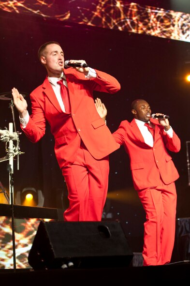 Airman 1st Class Alexander Ross and Staff Sgt. Jamal Young, Tops in Blue vocalist, dance during a Tops in Blue performance at Osan Air Base, Republic of Korea, Aug. 2, 2014. Each team begins their nine month temporary duty with a 60 day training period at Lackland Air Force Base, Texas. (U.S Air Force photo by Senior Airman Matthew Lancaster)