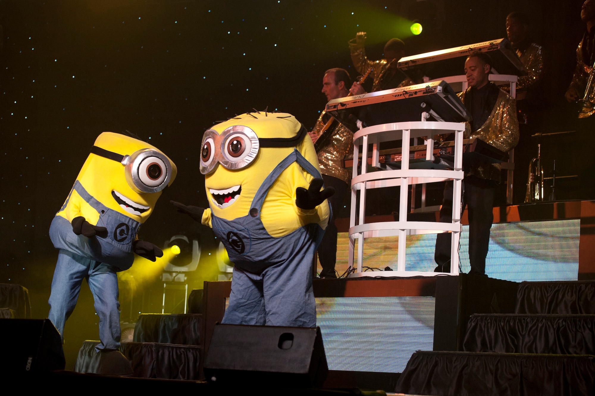 Tops in Blue members, dressed as minions from “Despicable Me”, dance during a Tops in Blue performance at Osan Air Base, Republic of Korea, Aug. 2, 2014. Each touring group member has non-performing duties assigned such as the wardrobe. The wardrobe crews quickly learn their job, which includes ironing or steaming each and every costume before every show. (U.S Air Force photo by Senior Airman Matthew Lancaster)