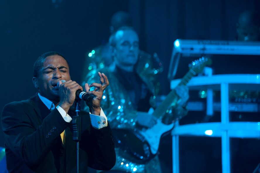 Senior Airman Charles Cooper, Tops in Blues vocalist, sings during a Tops in Blue performance at Osan Air Base, Republic of Korea, Aug. 2, 2014.Tops in Blue has featured over 1,700 airmen in their shows during the past 60 years. (U.S Air Force photo by Senior Airman Matthew Lancaster)