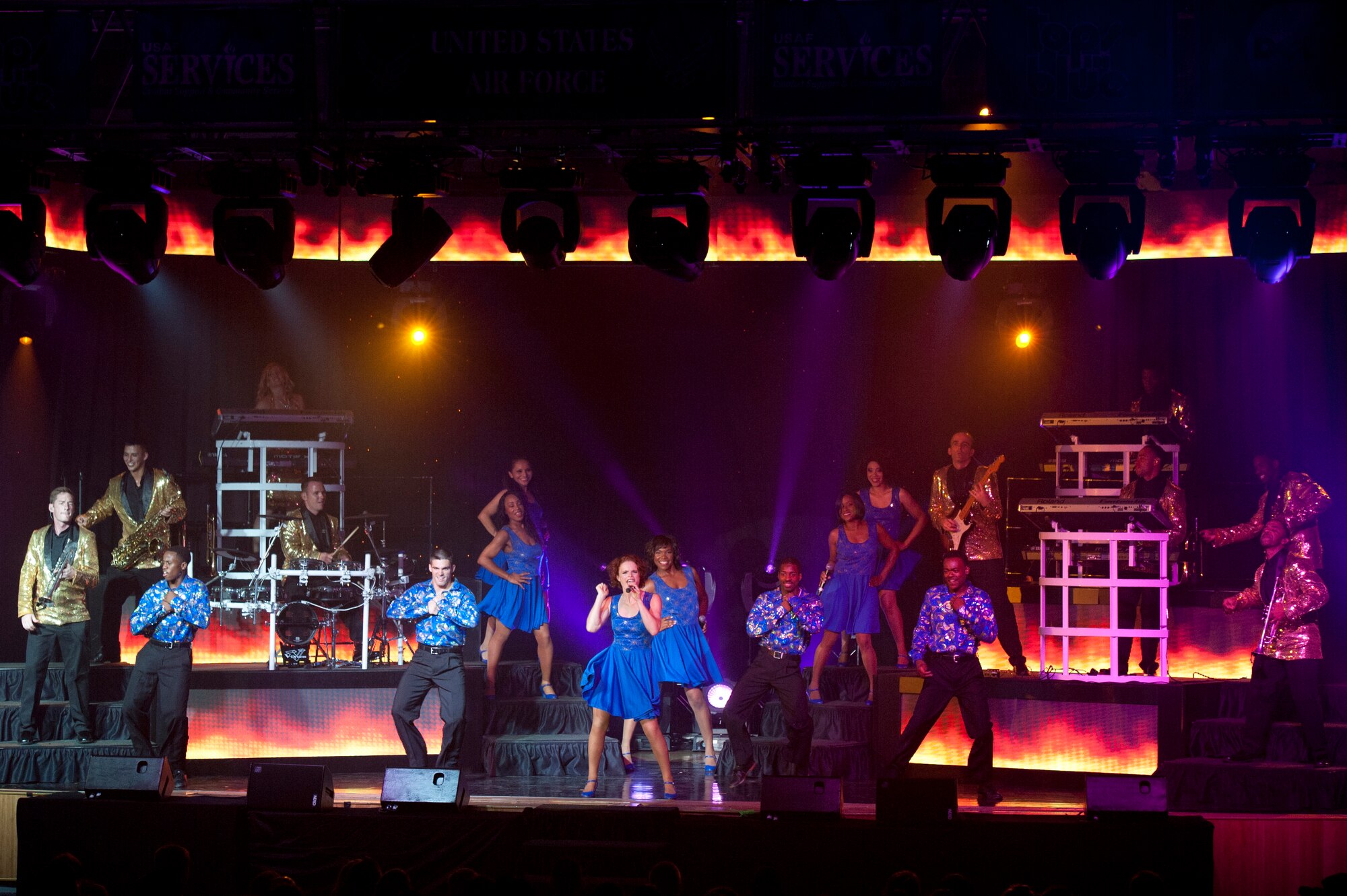 Tops in Blue members sing, dance and play various instruments during a Tops in Blue performance at Osan Air Base, Republic of Korea, Aug. 2, 2014. Tops in Blue serves as an expeditionary entertainment unit to provide quality entertainment from within Air Force resources for the Air Force family, while simultaneously promoting community relations, supporting recruiting efforts and serving as ambassadors for the United States of America and the United States Air Force. (U.S Air Force photo by Senior Airman Matthew Lancaster)