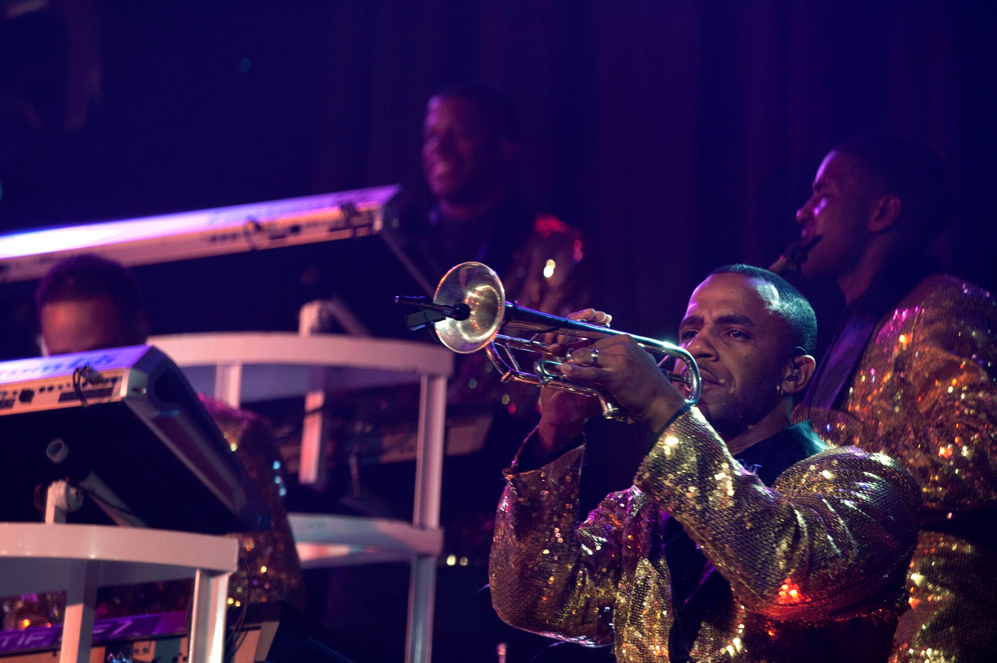 Master Sgt. Alonzo Deon III, Tops in Blue trumpeter, plays his instrument during a Tops in Blue performance at Osan Air Base, Republic of Korea, Aug. 2, 2014. Every Tops in Blue member is also the set up and tear down crew. They unload and set up over 60,000 pounds of equipment for each performance. (U.S Air Force photo by Senior Airman Matthew Lancaster)