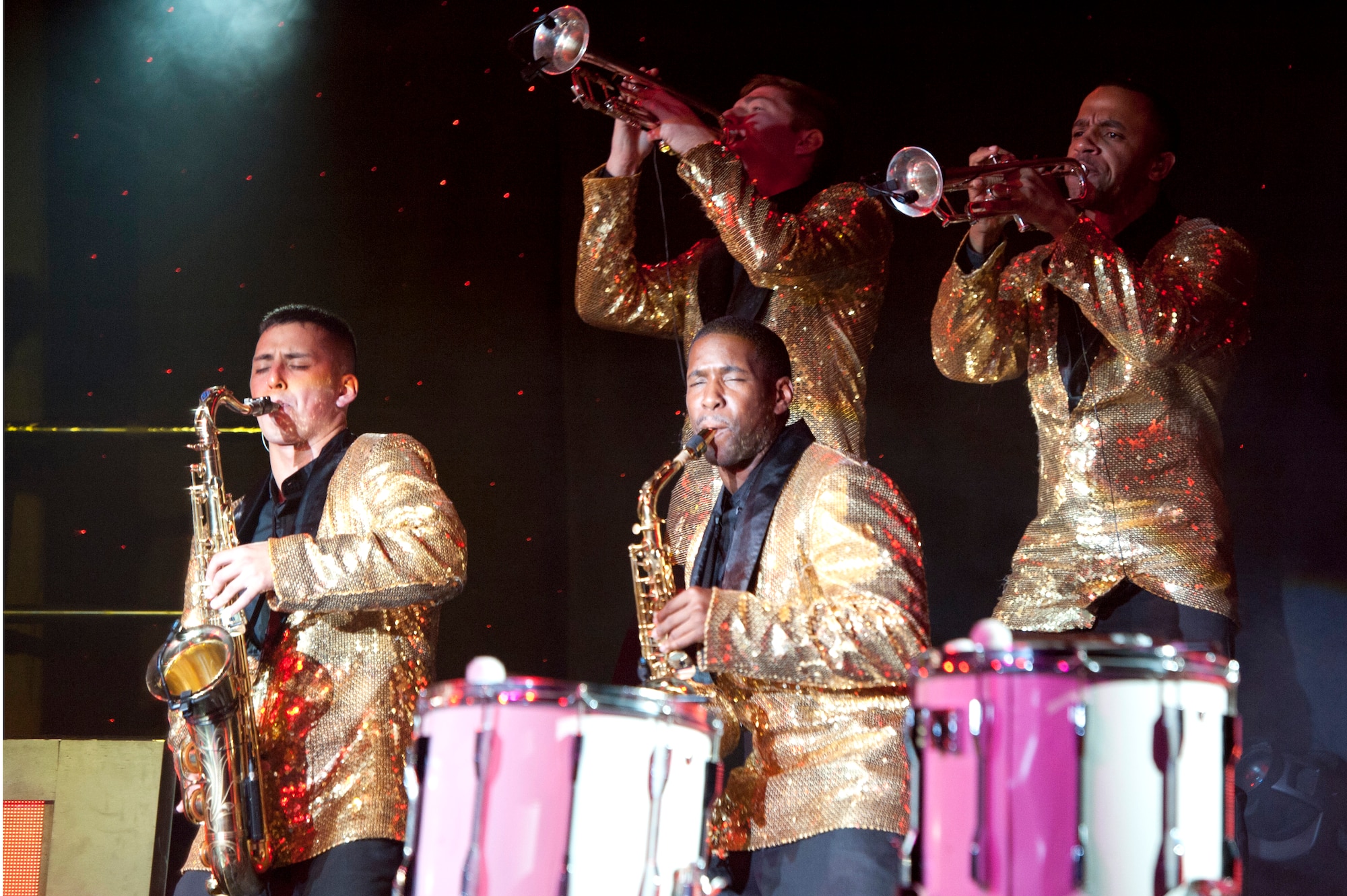 Tops in blue members play saxophones and trumpets during a Tops in Blue performance at Osan Air Base, Republic of Korea, Aug. 2, 2014. A Tops in Blue team has 35 to 40 members of vocalists, musicians, dancers, and technicians. (U.S Air Force photo by Senior Airman Matthew Lancaster)