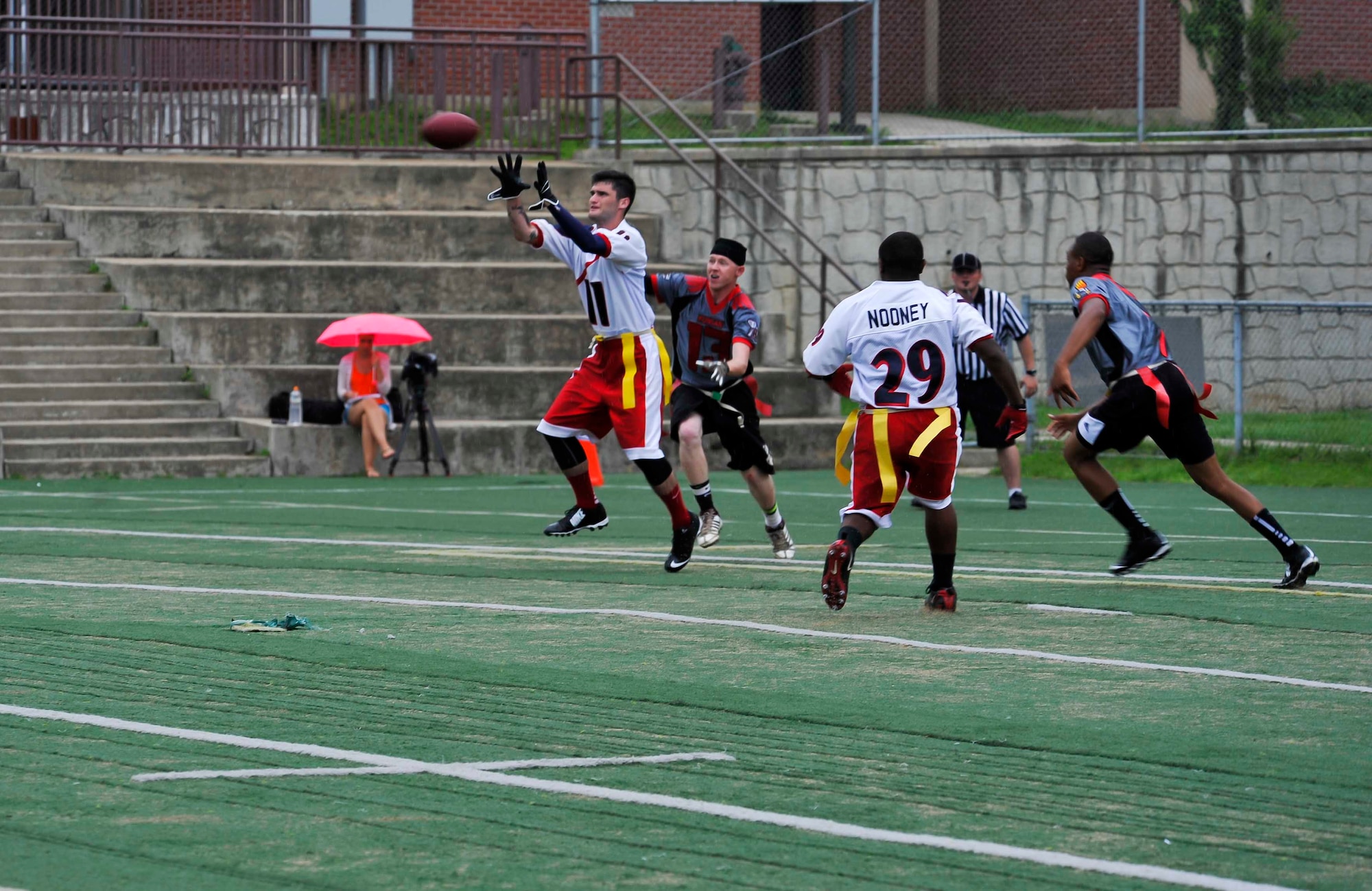 U.S. Army Private First Class Satcha Hooten, 52nd Air Defense Artillery Regiment early morning specialist, catches the ball in the end zone in the first half of the championship game against Kunsan Air Base, Republic of Korea, at the high school football field on Osan AB, ROK, Aug. 3, 2014. Osan defeated Kunsan in both games making them the Kings of the ROK. (U.S. Air Force photo/Senior Airman David Owsianka)