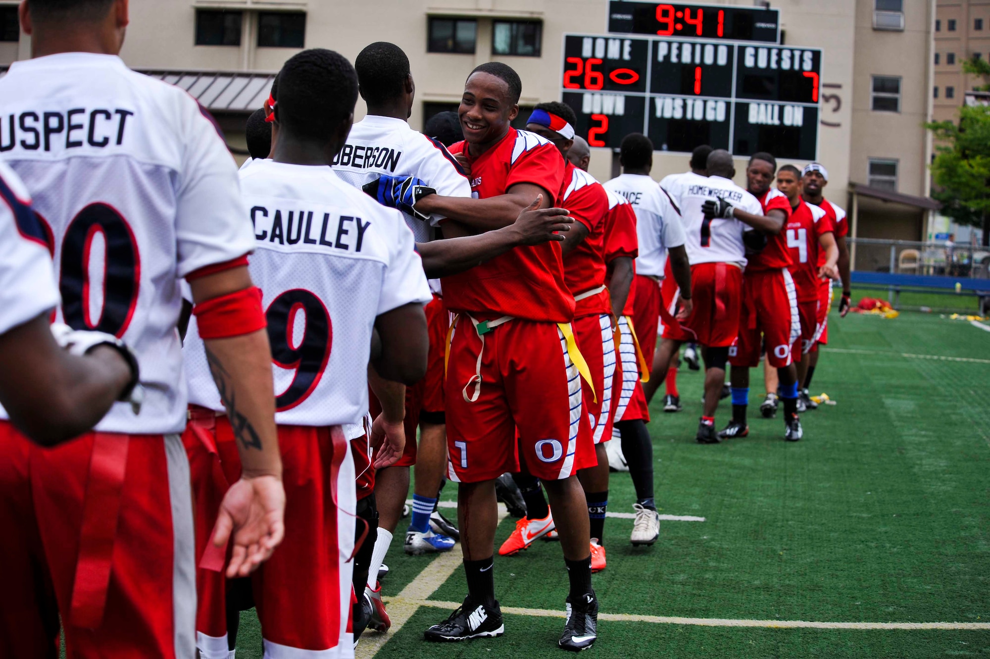 Both Osan teams congratulate each other after the semifinals game at the high school football field on Osan Air Base, Republic of Korea, Aug. 3, 2014. Osan’s Team 1 moved onto the championship game against Kunsan Air Base, ROK. (U.S. Air Force photo/Senior Airman David Owsianka)