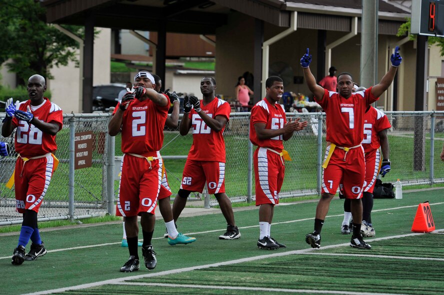 Members of the Osan flag football team 2 celebrate after scoring a touchdown in the second half against the Area 1 Army Base, Republic of Korea, football team at the high school football field on Osan Air Base, ROK, Aug. 3, 2014. Osan’s Team 2 moved on to the semifinals. (U.S. Air Force photo/Senior Airman David Owsianka)