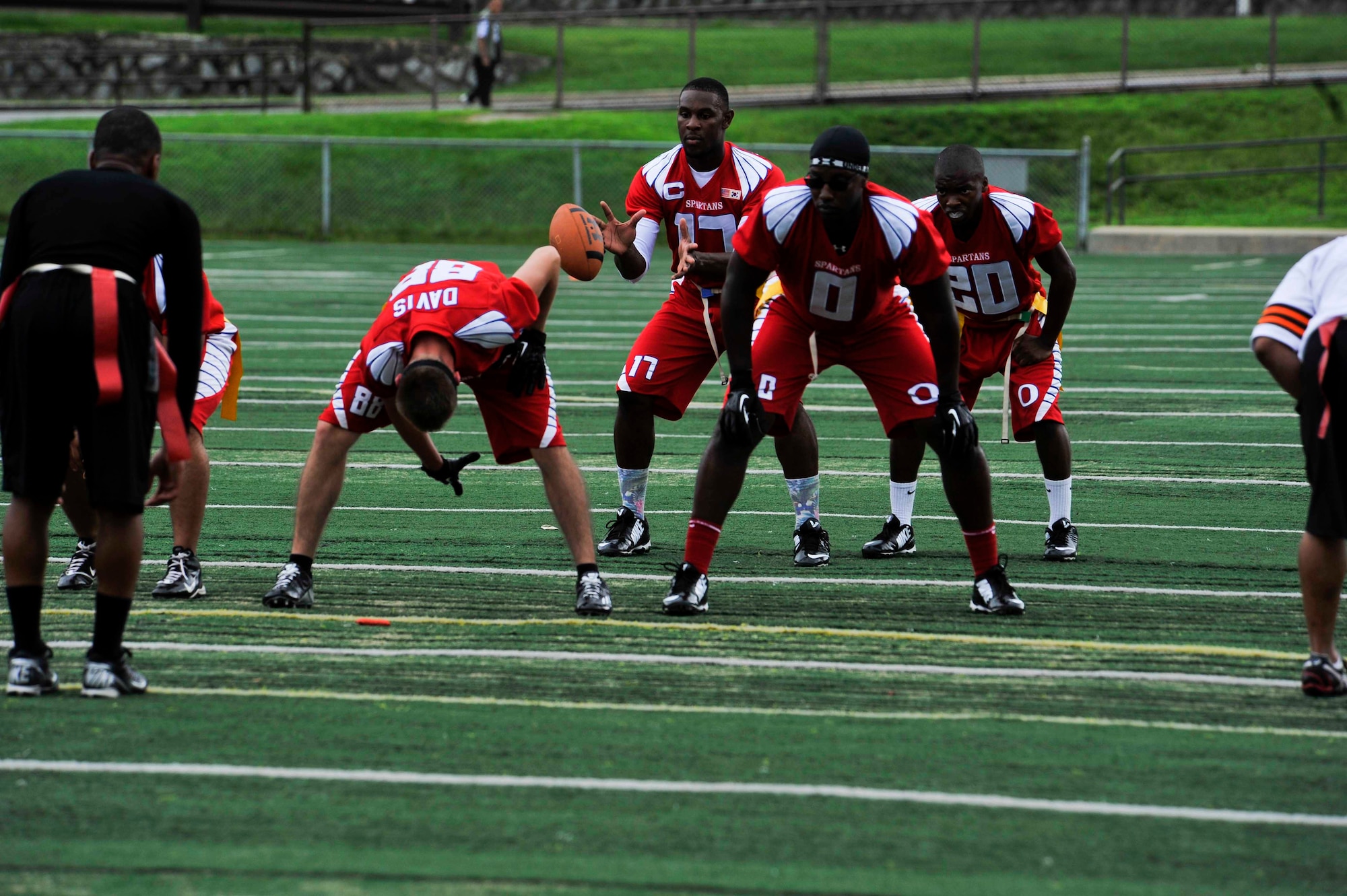 Senior Airman Aaron Wynn, 51st Medical Support Squadron medical logistics technician, prepares to catch the ball during the first half of the game against the Area 1 Army Base, Republic of Korea, football team at the high school football field on Osan Air Base, ROK, Aug. 3, 2014. Osan’s Team 2 won the game 28-6. (U.S. Air Force photo/Senior Airman David Owsianka)