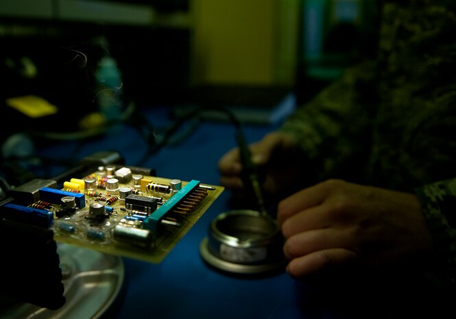 Staff Sgt. Tyle Wilson, 57th Maintenance Group Air Force Repair and Enhancement Program technician, prepares to work on an electrical piece of an aircraft at Nellis Air Force Base, Nev., Aug. 4, 2014. The AFREP shop takes unserviceable items that were turned into the supply system, repairs the component at a fraction of what it would cost a contractor, and returns it to the 57th MXG’s flight service center. (U.S. Air Force photo by Staff Sgt. Siuta B. Ika)