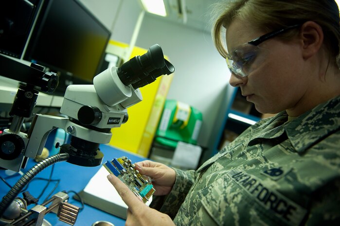 Staff Sgt. Tyle Wilson, 57th Maintenance Group Air Force Repair and Enhancement Program technician, looks over an electrical piece of an aircraft at Nellis Air Force Base, Nev., Aug. 4, 2014. In fiscal year 2013, the Nellis AFREP shop led all of Air Combat Command with more than $3 million in savings, and so far in FY 14, the shop has produced a cost savings of $2.5 million. (U.S. Air Force photo by Staff Sgt. Siuta B. Ika)