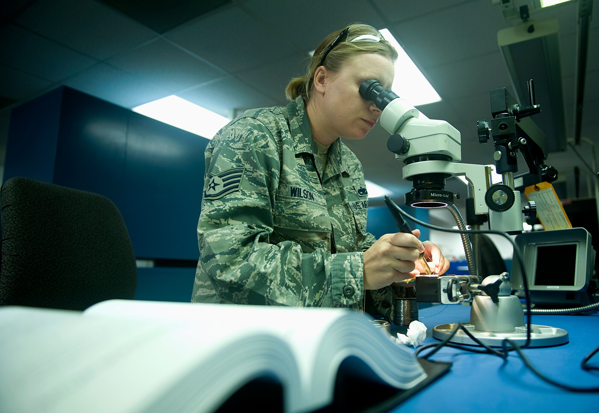 Staff Sgt. Tyle Wilson, 57th Maintenance Group Air Force Repair and Enhancement Program technician, works on an electrical piece of an aircraft at Nellis Air Force Base, Nev., Aug. 4, 2014. The AFREP shop takes unserviceable items that were turned into the supply system, repairs the component at a fraction of what it would cost a contractor, and returns it to the 57th MXG’s flight service center. (U.S. Air Force photo by Staff Sgt. Siuta B. Ika)