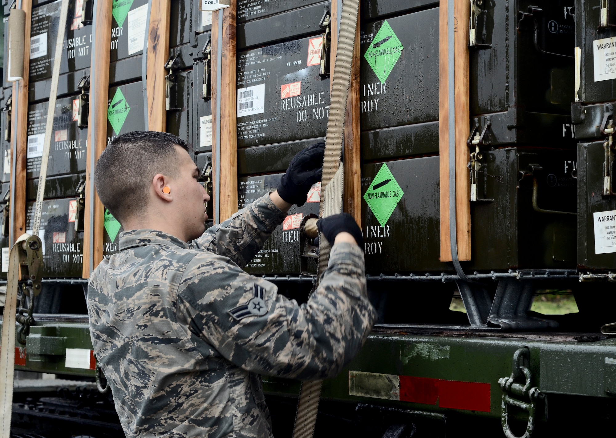 Airman 1st Class Jack Mowery, 36th Munitions Squadron Material Flight storage crew member, straps down a pallet of guidance controlled units July 30, 2014, on Andersen Air Force Base, Guam. The 36th MUNS is home to the largest munition stock pile in the world, valued at $1.3 billion, the material flight also ensures proper storage practices are utilized, inspect and maintain the munitions and ensure accountability of over 9 million individual items. (U.S. Air Force photo by Staff Sgt. Robert Hicks/Released)