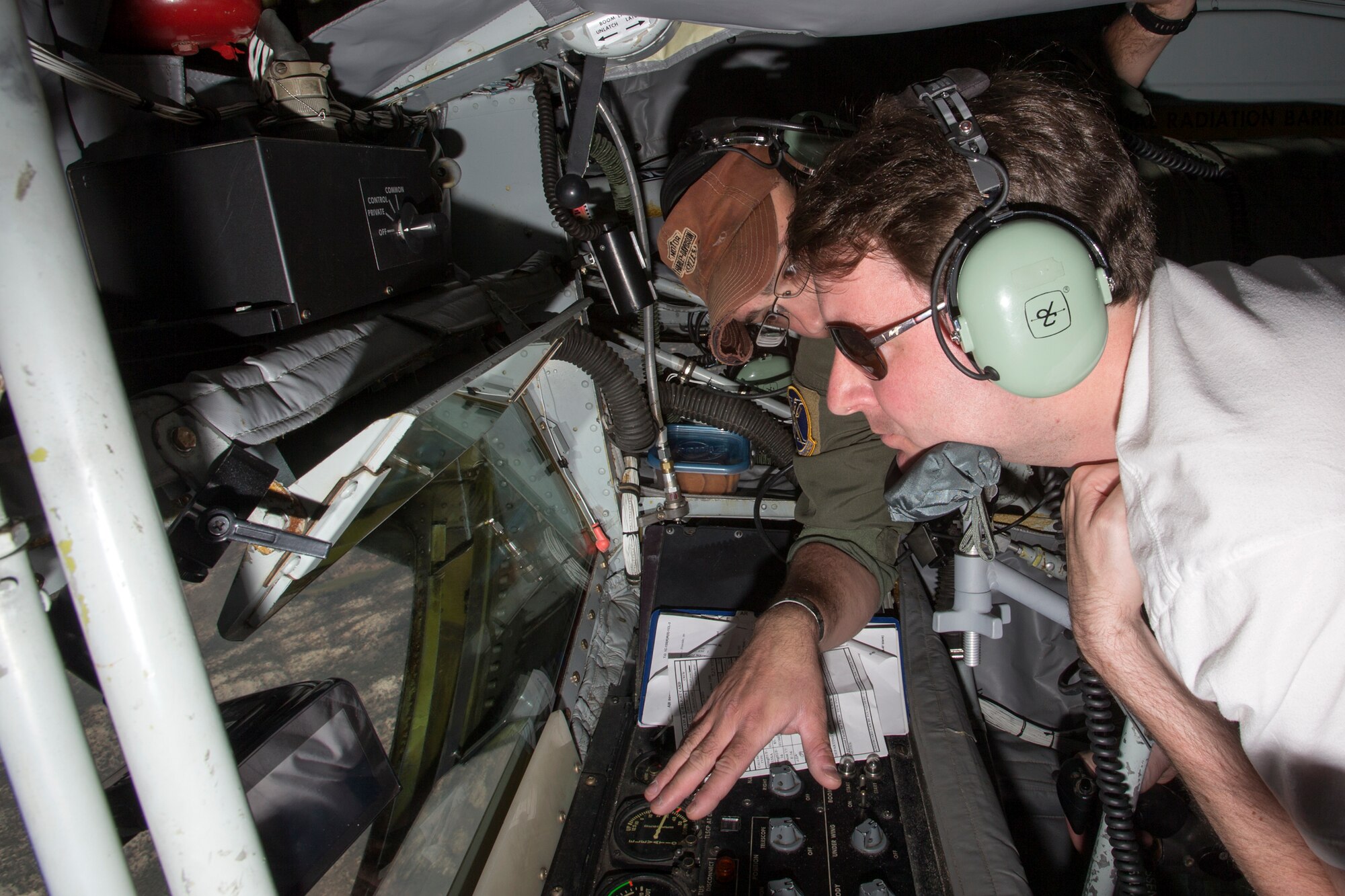 The staffers began the second day of their visit, Aug. 5, by participating in a pre-flight brief at Test Operations in preparation for a flight aboard a KC-135 Stratotanker. During the test flight, the KC-135, known as "The Mighty War Wagon," extended its flying boom to refuel an F-15 and an F-16 in flight. The Stratotanker is capable of pumping nearly all of its internal fuel through the flying boom, its primary fuel transfer method. Each staffer was given the chance to lie in the boom pod where the boom operator controls the boom. (U.S. Air Force photo by Christian Turner)