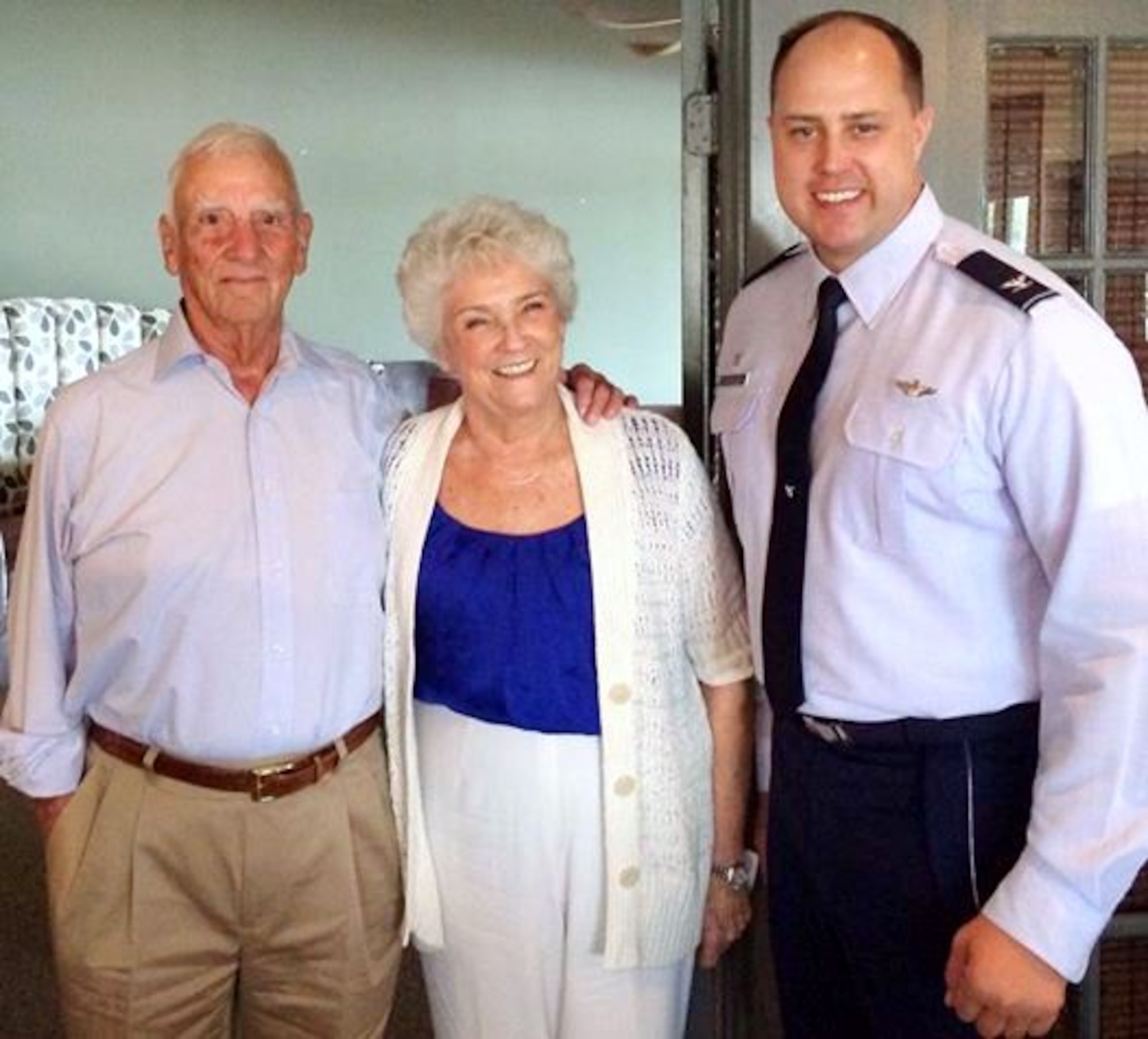 (Ret.) Col. Carlyle "Smitty" Harris, his wife Louise, and Col. John Nichols, 14th Flying Training Wing Commander, pause for a photo at South restaurant in Tupelo, Mississippi Aug. 4.  Harris was one of the original creators of the TAP code, which was used to communicate to the other prisoners in the solitary confinement.