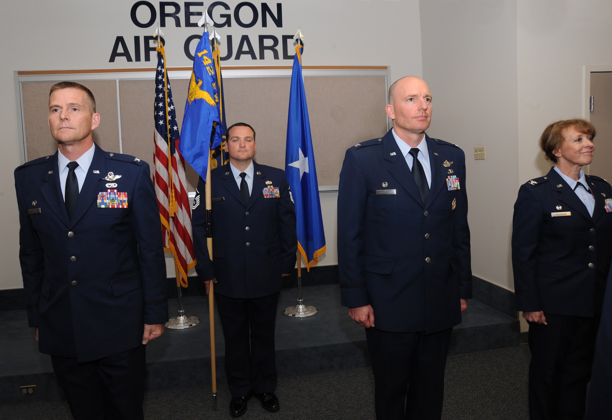 Col. Rick Wedan, 142nd Fighter Wing Commander, left, Master Sgt. Robert Vickery, center left, Col. Paul Fitzgerald, center right, and Col. Donna Prigmore, right, await the exchange of colors during the Mission Support Group Change of Command Ceremony, Portland Air National Guard Base, Ore., Aug. 3, 2014. (U.S. Air National Guard photo by Tech. Sgt. John Hughel, 142nd Fighter Wing Public Affairs/Released)