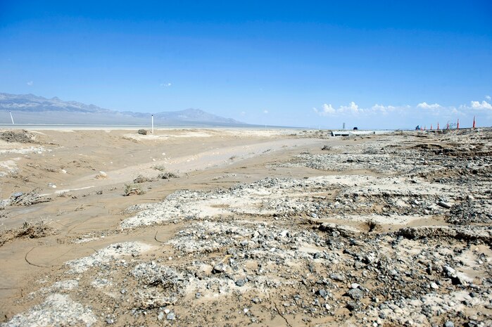 The scene on U.S. Route 95, mile marker 100, north of Las Vegas, Nev., on Aug. 5, 2014, where three Nellis Air Force Base, Nev., Airmen assigned to the 820th RED HORSE, who were assisted by three members of the 799th Air Base Squadron, saved an elderly couple whose car was stuck in the mud during a flash flood on Aug. 4. The Airmen were driving south bound from their work sites at Creech AFB when they saw the couple’s car stuck in the median, and took swift action before the flood carried the car away. (U.S. Air Force photo by Staff Sgt. Siuta B. Ika)