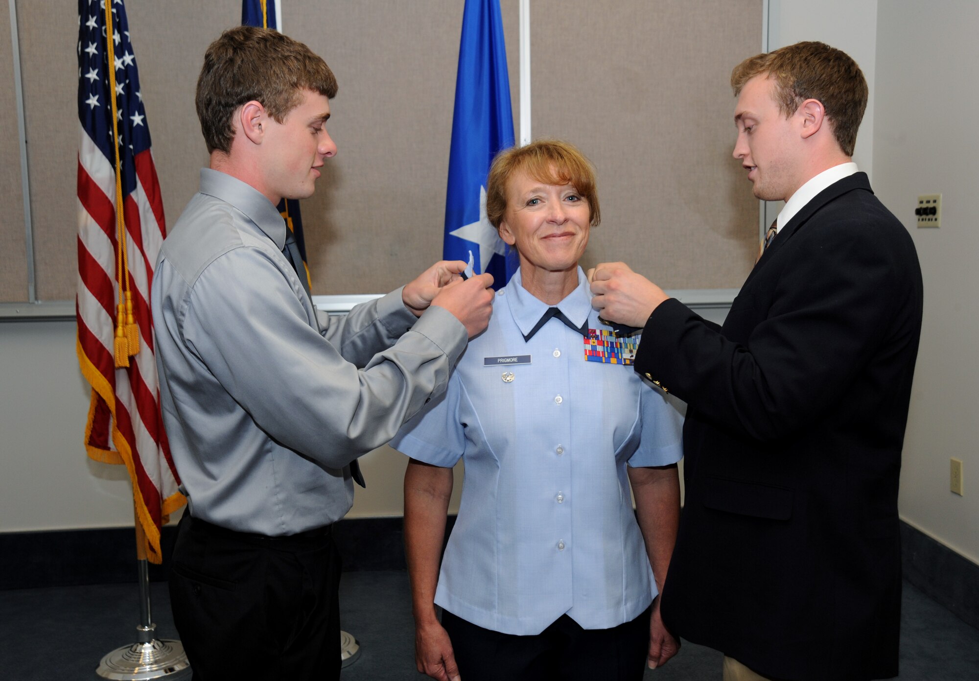 Lt. Col. Donna Prigmore is promoted to the rank of Colonel with the assistance of her two sons, Brian and Nathan Prigmore, during her promotion ceremony held at the Portland Air National Guard Base, Ore., Aug. 3, 2014. (U.S. Air National Guard photo by Tech. Sgt. John Hughel, 142nd Fighter Wing Public Affairs/Released)