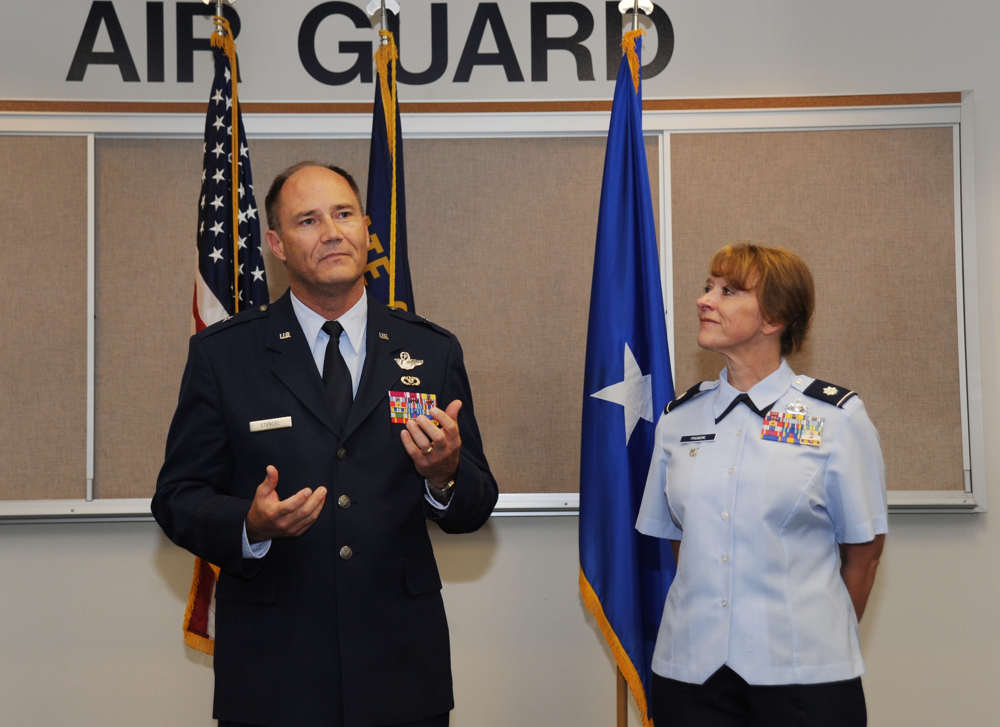 Brig. Gen. Michael Stencel, Commander of the Oregon Air National Guard, left, address those in attendance to the promotion and Lt. Col. Donna Prigmore, right, and the Change of Command ceremony for the 142nd Fighter Wing Mission Support Group held at the Portland Air National Guard Base, Ore., Aug. 3, 2014. (U.S. Air National Guard photo by Tech. Sgt. John Hughel, 142nd Fighter Wing Public Affairs/Released)