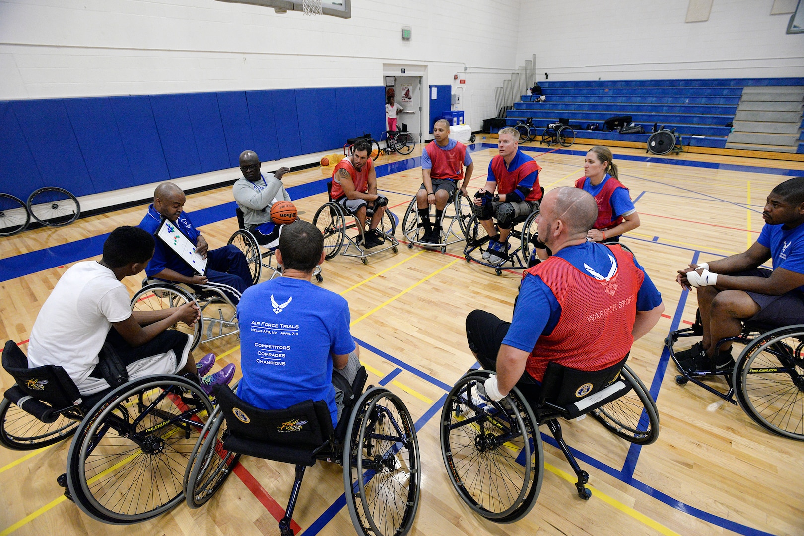 Wounded warriors gather around to learn a play during the final Warrior Games training camp at the Academy Aug. 5. More than 60 wounded veterans from across the country participated in the final Warrior and Invictus Games training camp here Aug. 3-7 to prepare for the fall games, motivate others and take a healthy step toward recovery. (U.S. Air Force photo/Mike Kaplan)