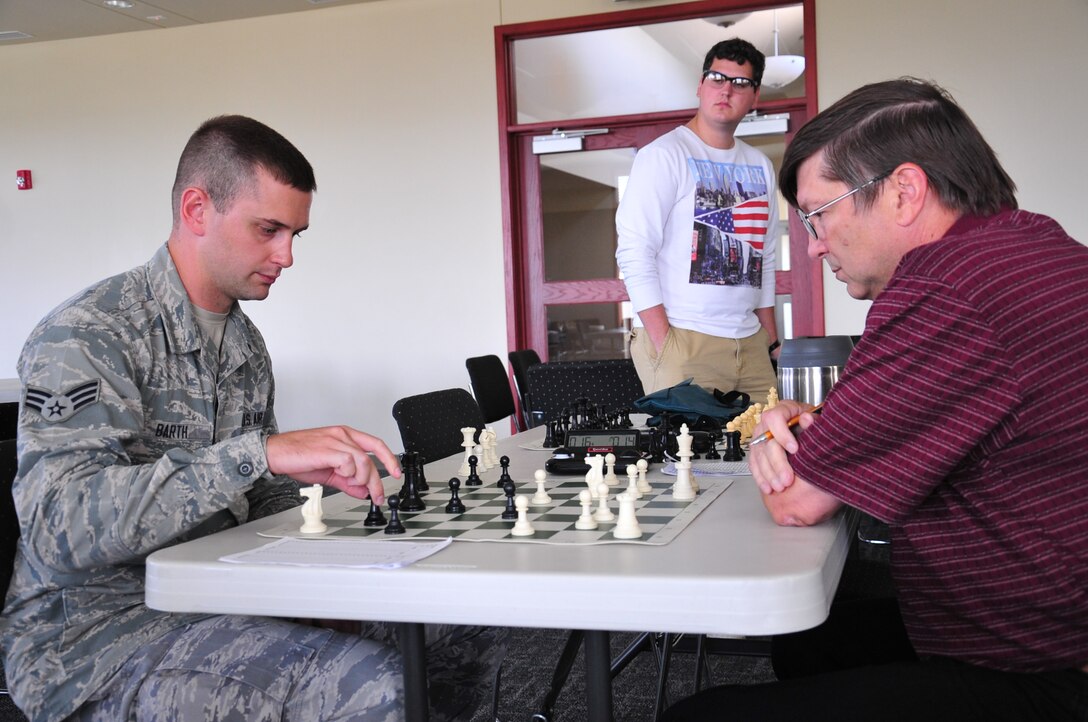 Senior Airman Caleb Barth, 55th Strategic Communications Squadron, squares off against Raymond Brooks, 55th CS, at the first Chess Fair that was held at The Point in Rising View housing located near Offutt Air Force Base, Nebraska. Proceeds from the event went to the Husker Salute Organization.
(U.S. Air Force photo by D.P. Heard/Released)
