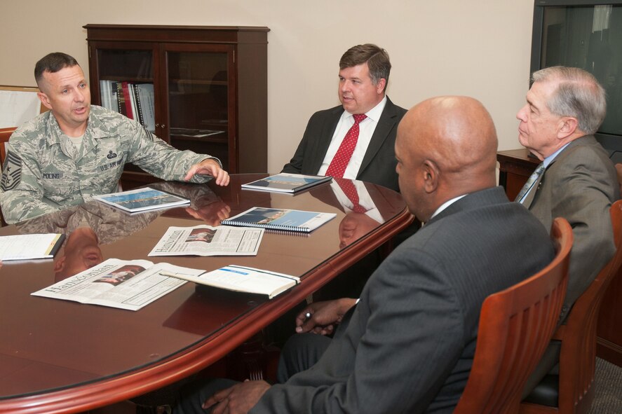 HANSCOM AIR FORCE BASE, Mass. – Command Chief Master Sgt. Craig A. Poling speaks to retired 9th Master Chief Petty Officer of the Navy Jim Herdt (far right) and retired 14th Sergeant Major of the Marine Corps Alford McMichael,   to discuss their quality assurance visit to the Transition Assistance Program seminar Aug. 6, while Tom Fredericks (center), 66th Air Base Group deputy director, looks on. During the visit, Herdt and McMichael looked at the new Department of Veterans Affairs Benefits I and II briefing, as well as speaking with servicemembers who recently completed the TAP Seminar and the VA benefit advisor staff. (U.S. Air Force photo by Mark Herlihy)