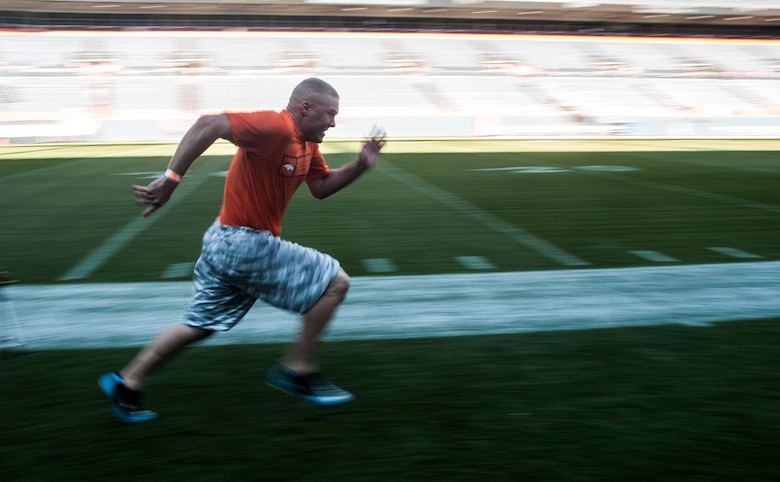 Joshua Manske, 50th Civil Engineer Squadron, runs the 40-yard dash as part of the USAA-Broncos Military Combine Aug. 2, 2014, at Sports Authority Field in Denver. Manske was one of the service members from Schriever and Peterson Air Force Bases, U.S. Air Force Academy and Fort Carson who participated in the military combine. (U.S. Air Force photo/Staff Sgt. Julius Delos Reyes)