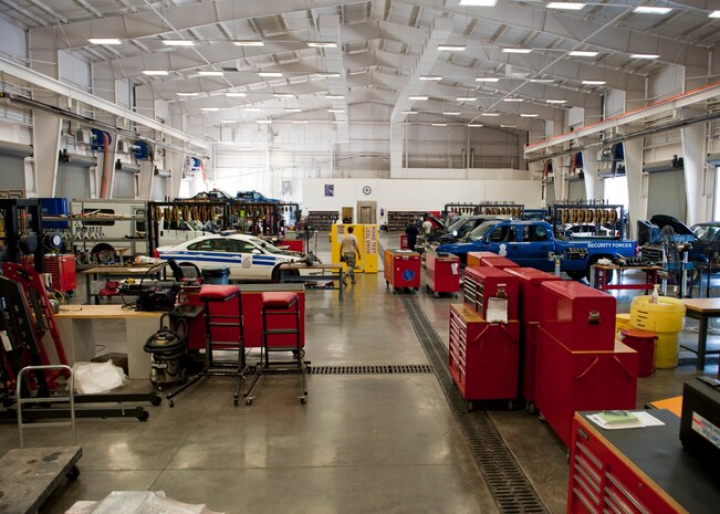 Airmen assigned to the 99th Logistics Readiness Squadron vehicle maintenance flight repair and maintain government owned vehicles at Nellis Air Force Base, Nev. Aug. 5, 2014.  The 80,000 square foot state of the art facility helps the flight manage more than 1,800 vehicles, the largest fleet in Air Combat Command. (U.S. Air Force photo by Airman 1st Class Thomas Spangler)