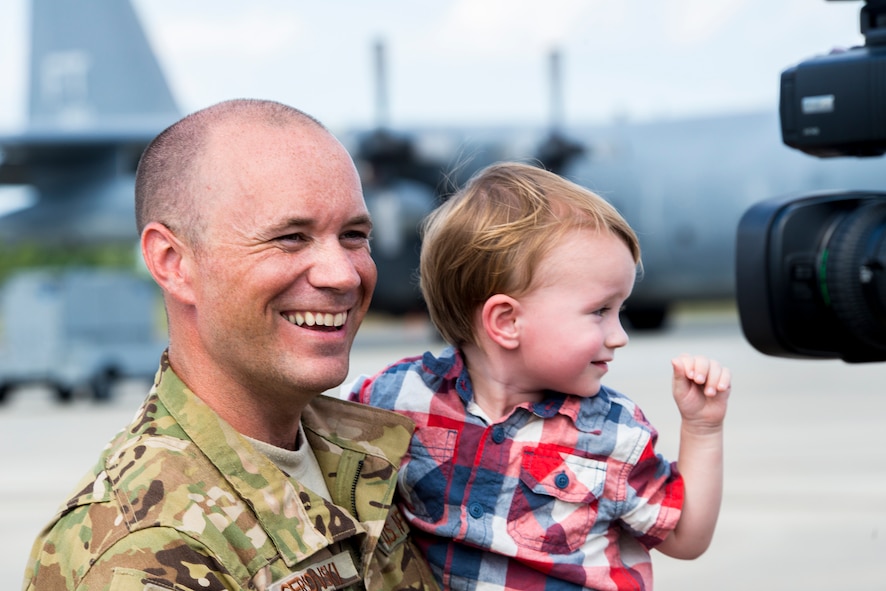 U.S. Air Force Capt. C.J. Cersovski, 71st Rescue Squadron HC-130P Combat King pilot, laughs with his son Leo during an interview with local media at Moody Air Force Base, Ga., Aug. 5, 2014. The deployment was Cersovski’s fifth total and second since Leo’s birth. (U.S. Air Force photo by Airman 1st Class Ryan Callaghan/Released)