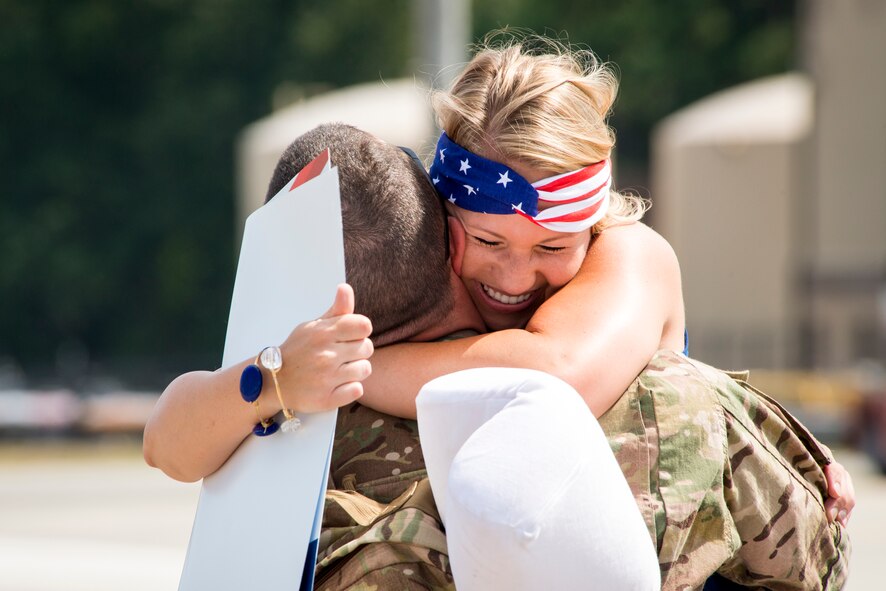 U.S. Air Force Staff Sgt. Michael Patterson, 723d Aircraft Maintenance Squadron aerospace propulsion craftsman, greets his wife Ashley at Moody Air Force Base, Ga., Aug. 5, 2014. Patterson was deployed for five months to support operations in Air Forces Africa. (U.S. Air Force photo by Airman 1st Class Ryan Callaghan/Released)