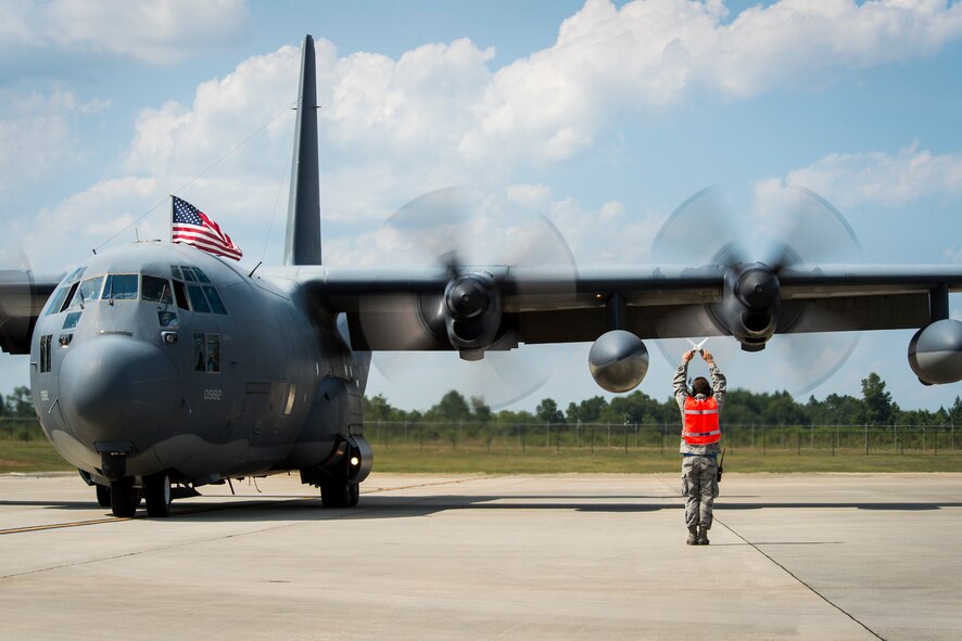 U.S. Air Force Senior Airman Shey Burns, 723d Aircraft Maintenance Squadron crew chief, marshals an HC-130P Combat King to a halt at Moody Air Force Base, Ga., Aug. 5, 2014. The aircraft has been in service for more than 50 years and just completed Moody’s final HC-130P deployment. (U.S. Air Force photo by Airman 1st Class Ryan Callaghan/Released)