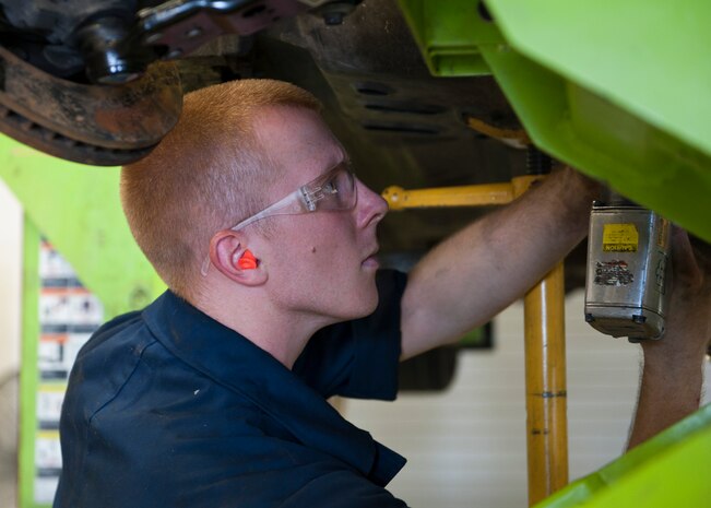 Airman 1st Class Troy Noel, 99th Logistics Readiness Squadron vehicle mechanic, finishes putting the engine back into a security forces vehicle at Nellis Air Force Base Nev. Aug. 5, 2014. The vehicle maintenance flight is comprised of 91 military members and 27 civilian workers. (U.S. Air Force photo by Airman 1st Class Thomas Spangler)