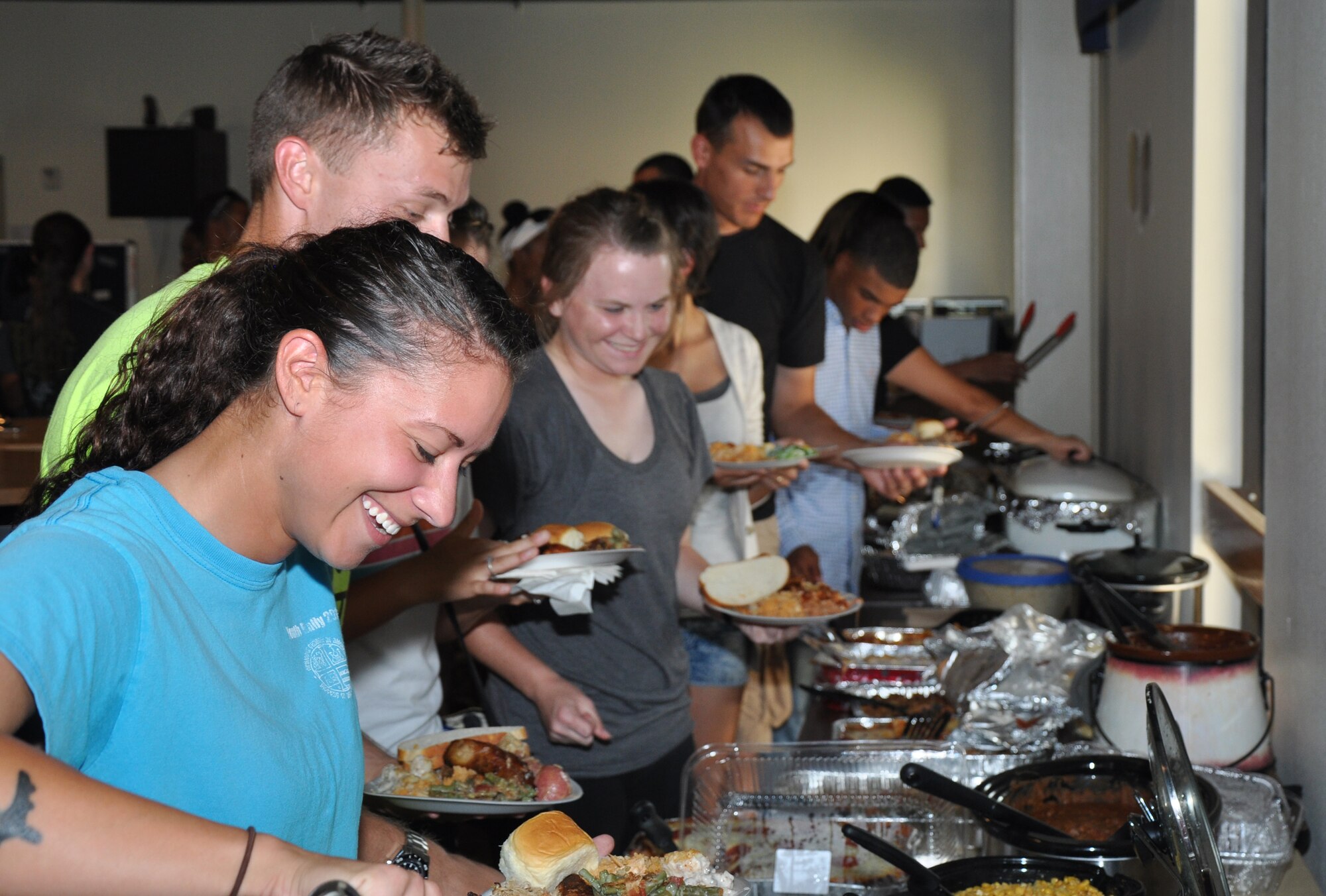 GOODFELLOW AIR FORCE BASE, Texas – Students go through a buffet line during the first Top 3 dorm dinner at the Crossroads Student Center here July 29. The 5/6 council assisted the Top 3 with the dinner by cooking extra meals and desserts. (U.S. Air Force photo/ Senior Airman Joshua Edwards)